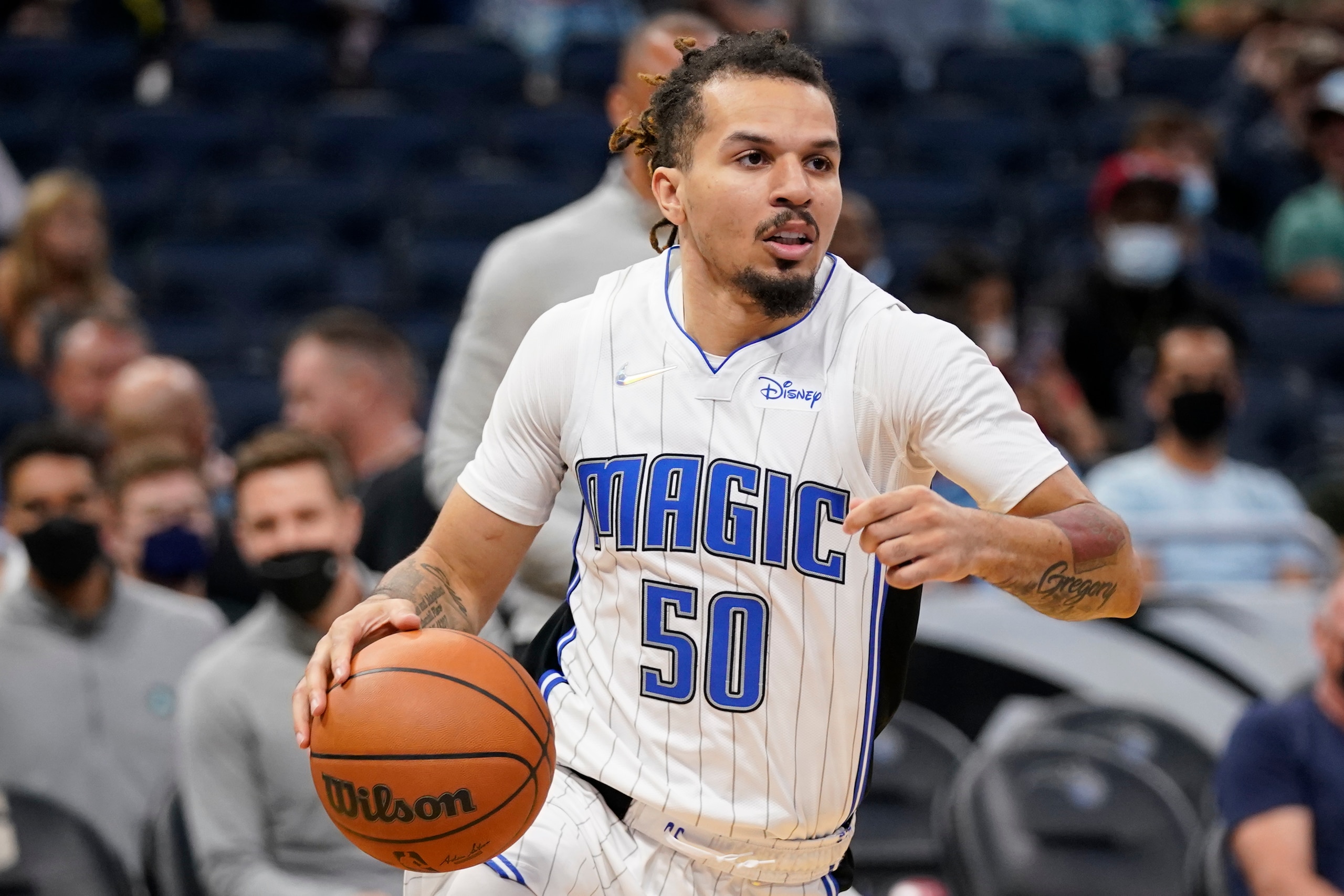 Orlando Magic guard Cole Anthony moves the ball ab= during the first half of an NBA preseason basketball game, Wednesday, Oct. 13, 2021, in Orlando, Fla. (AP Photo/John Raoux)