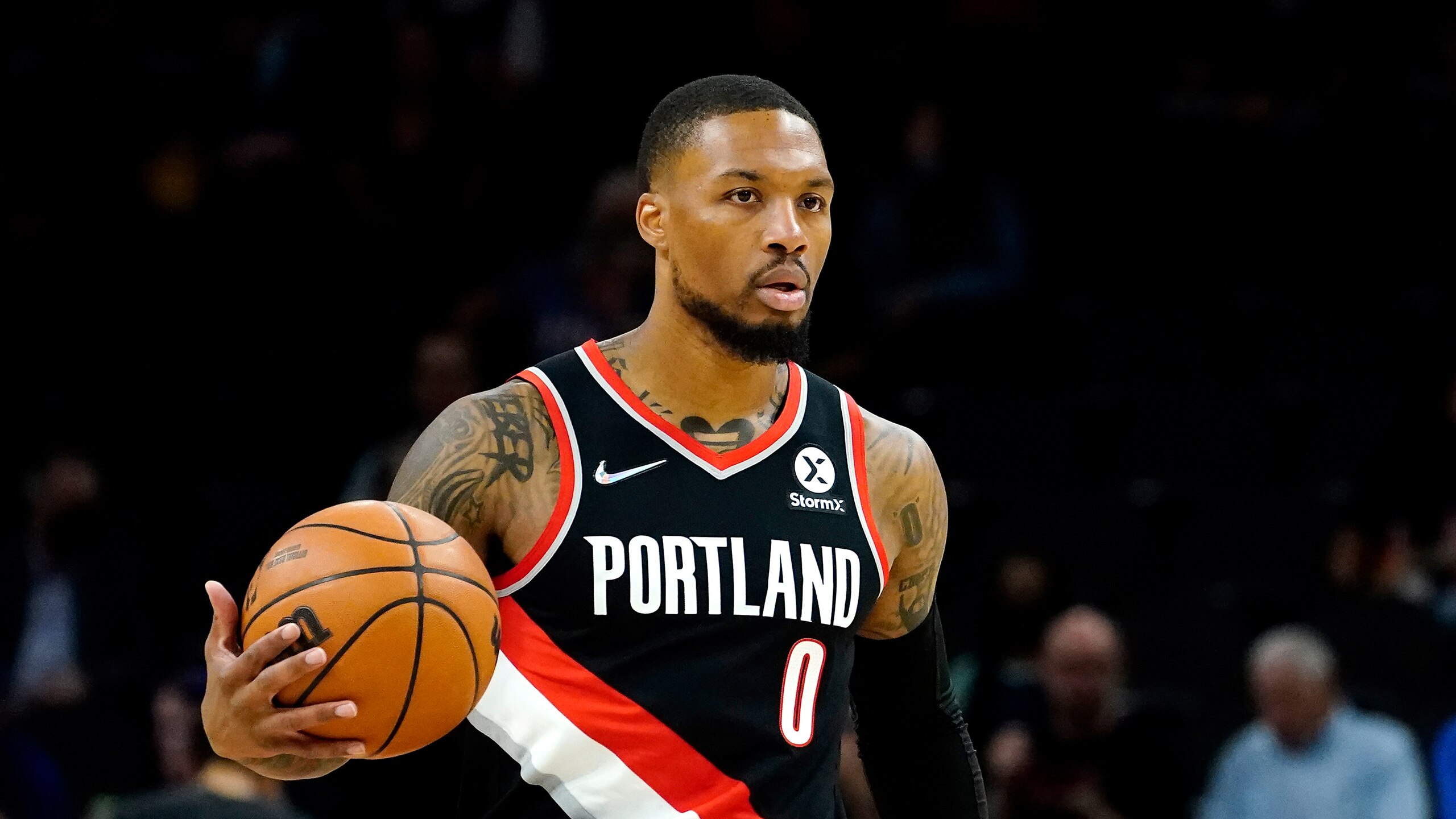 Portland Trail Blazers guard Damian Lillard (0) against the Phoenix Suns during the first half of a preseason NBA basketball game, Wednesday, Oct. 13, 2021, in Phoenix. (AP Photo/Matt York)