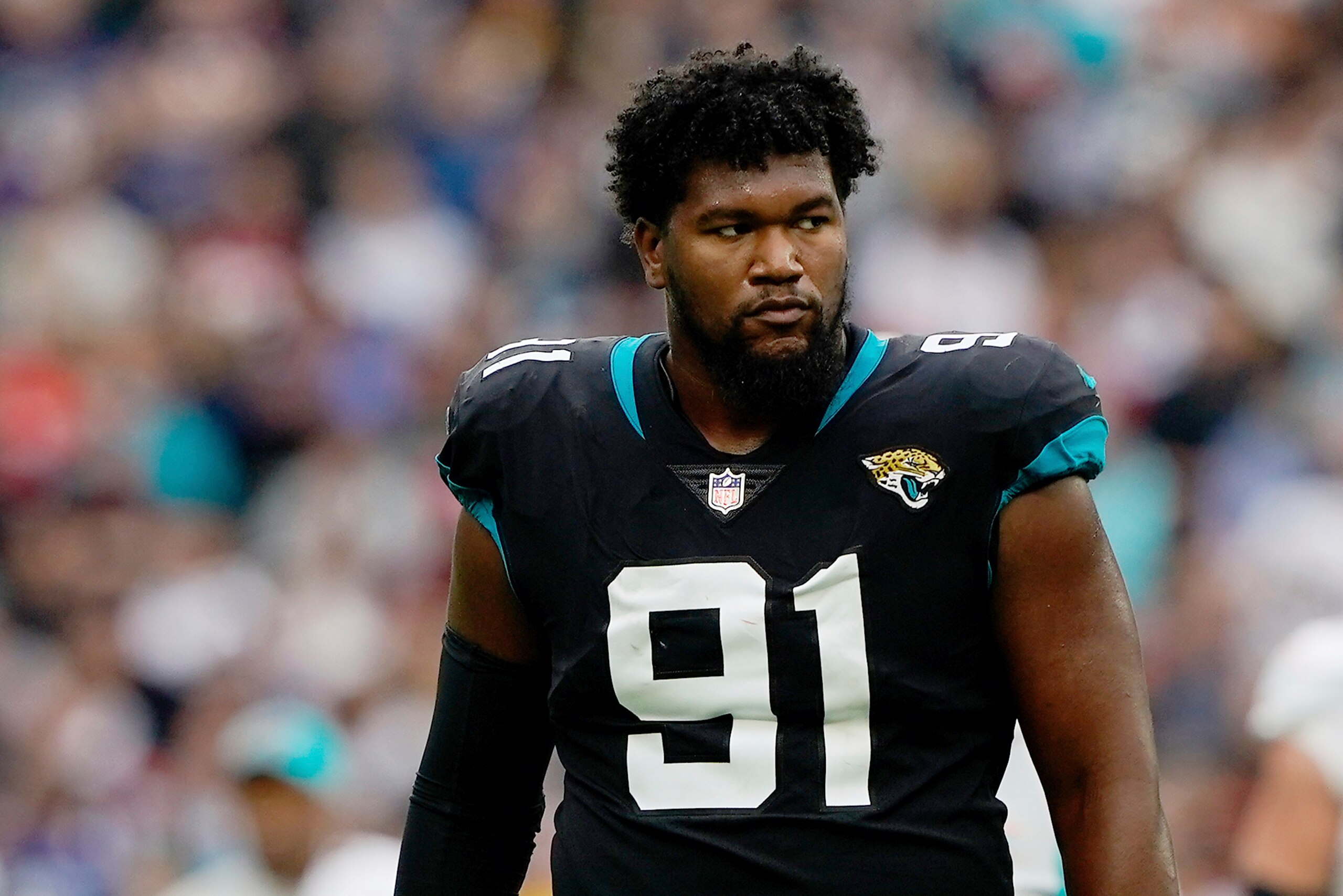 Jacksonville Jaguars defensive end Dawuane Smoot (91) looks on between plays during an NFL football game against the Miami Dolphins at Tottenham Hotspur Stadium in London, Sunday, Oct. 17, 2021. The Jacksonville Jaguars defeated the Miami Dolphins 23-20. (AP Photo/Steve Luciano) Jacksonville Jaguars defensive end Dawuane Smoot (91) looks on between plays during an NFL football game against the Miami Dolphins at Tottenham Hotspur Stadium in London, Sunday, Oct. 17, 2021. The Jacksonville Jaguars defeated the Miami Dolphins 23-20. (AP Photo/Steve Luciano)