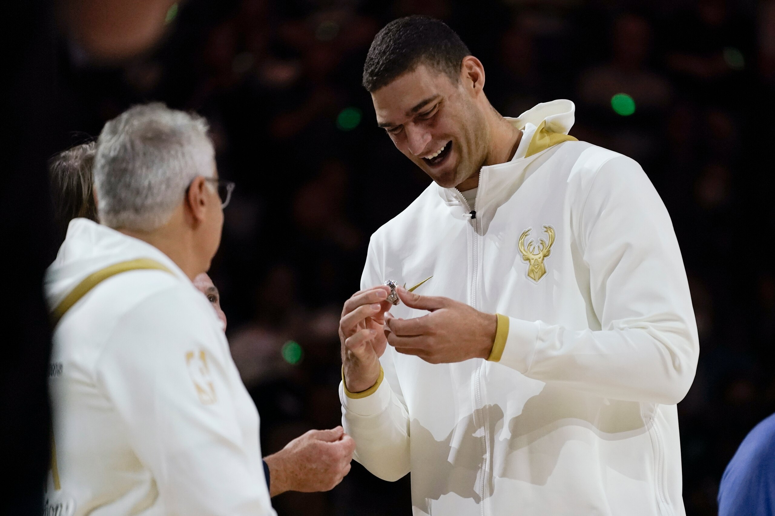 Milwaukee Bucks' Brook Lopez looks at his championship ring before the team's NBA basketball game against the Brooklyn Nets, Tuesday, Oct. 19, 2021, in Milwaukee. (AP Photo/Morry Gash)