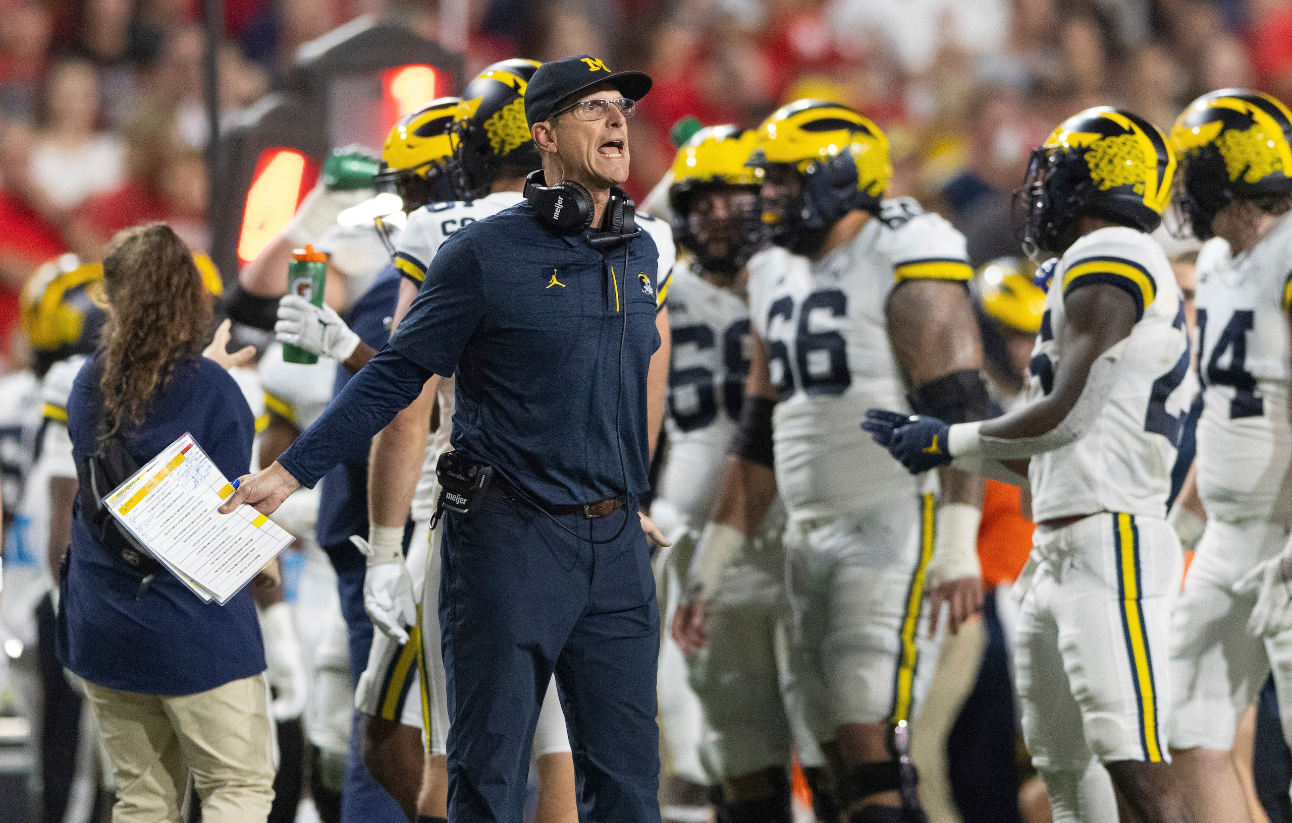 Michigan coach Jim Harbaugh yells to officials during a timeout in the first half of an NCAA college football game against Nebraska on Saturday, Oct. 9, 2021, in Lincoln, Neb. (AP Photo/Rebecca S. Gratz)