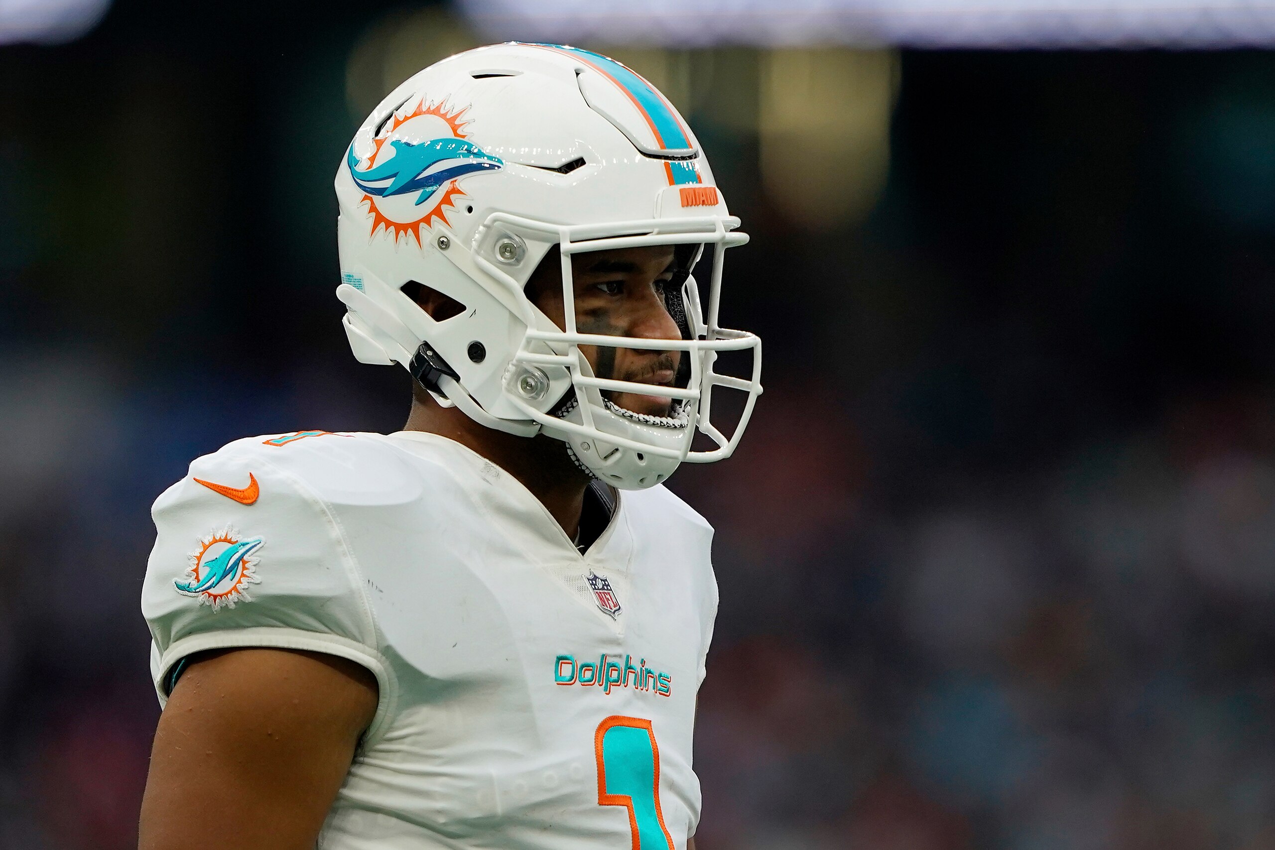 Miami Dolphins quarterback Tua Tagovailoa (1) walks on the field during an NFL football game against the Jacksonville Jaguars at Tottenham Hotspur Stadium in London, Sunday, Oct. 17, 2021. The Jacksonville Jaguars defeated the Miami Dolphins 23-20. (AP Photo/Steve Luciano)