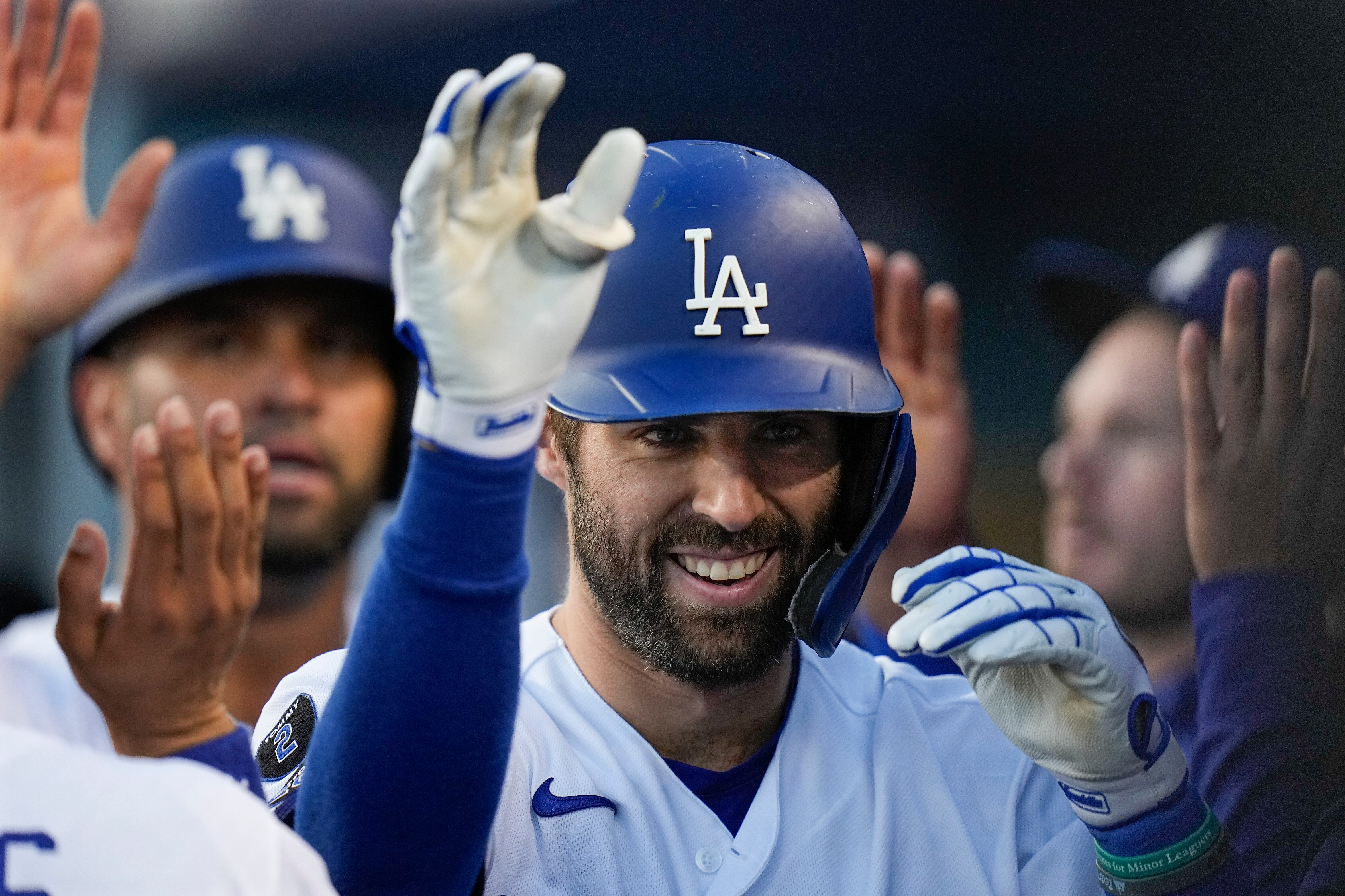 Los Angeles Dodgers' Chris Taylor is congratulated after his two-run home run in the second inning against the Atlanta Braves in Game 5 of baseball's National League Championship Series Thursday, Oct. 21, 2021, in Los Angeles. Pujols scored on the hit. (AP Photo/Jae C. Hong)