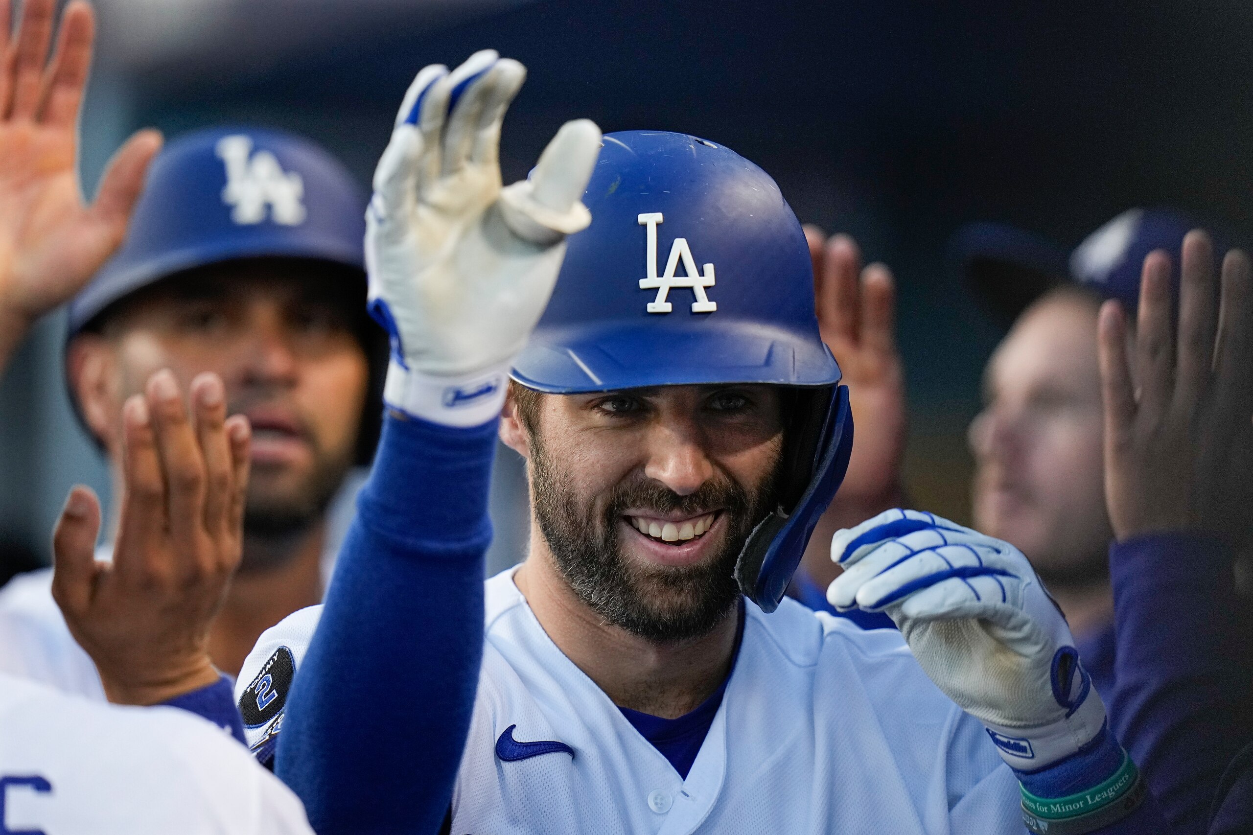 Los Angeles Dodgers' Chris Taylor is congratulated after his two-run home run in the second inning against the Atlanta Braves in Game 5 of baseball's National League Championship Series Thursday, Oct. 21, 2021, in Los Angeles. Pujols scored on the hit. (AP Photo/Jae C. Hong)