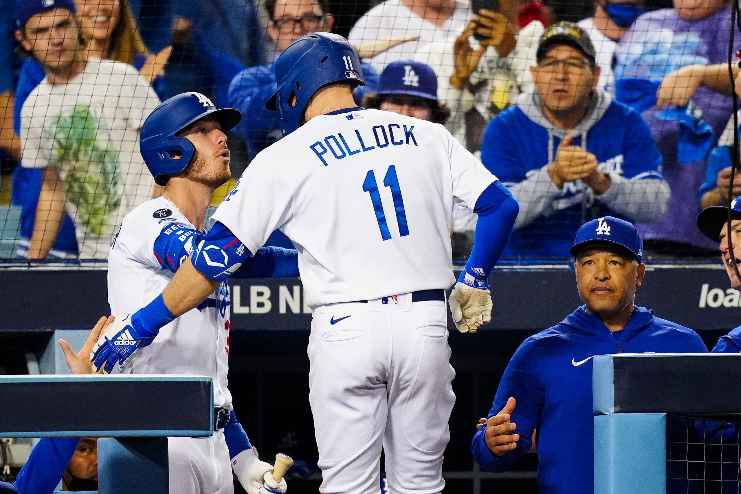 LOS ANGELES, CA - OCTOBER 21: AJ Pollock #11 celebrates with Cody Bellinger #35 of the Los Angeles Dodgers after hitting a three-run home run in the eighth inning during Game 5 of the NLCS between the Atlanta Braves and the Los Angeles Dodgers at Dodgers Stadium on Thursday, October 21, 2021 in Los Angeles, California. (Photo by Daniel Shirey/MLB Photos via Getty Images)