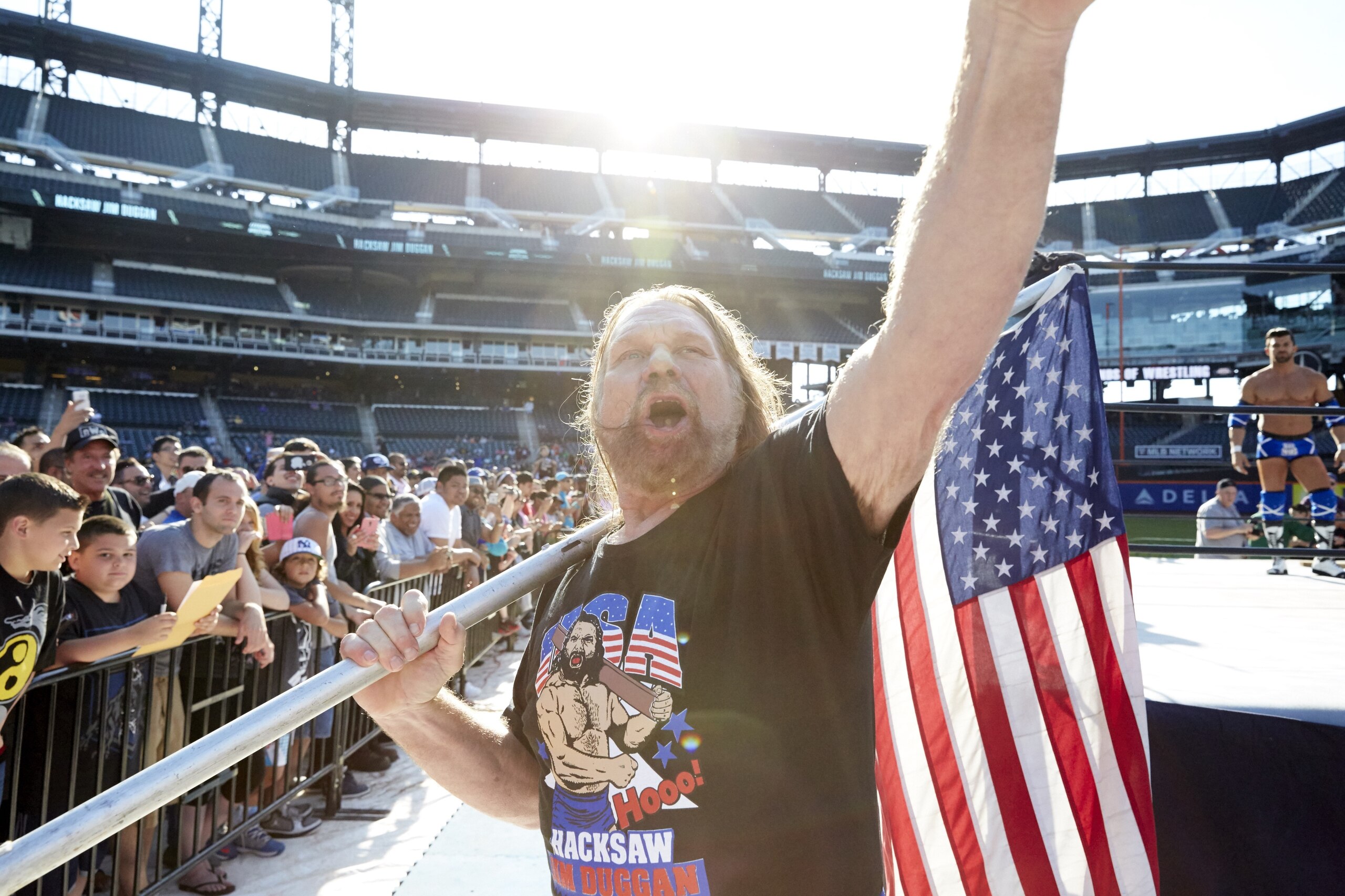 Wrestling: Legends of Wrestling: Hacksaw Jim Duggan carrying USA flag as he approaches fans and ring before fight at Citi Field. 
Flushing, NY 6/7/2015
CREDIT: William Baker (Photo by William Baker /Sports Illustrated via Getty Images)
(Set Number: X159685 TK1 )
