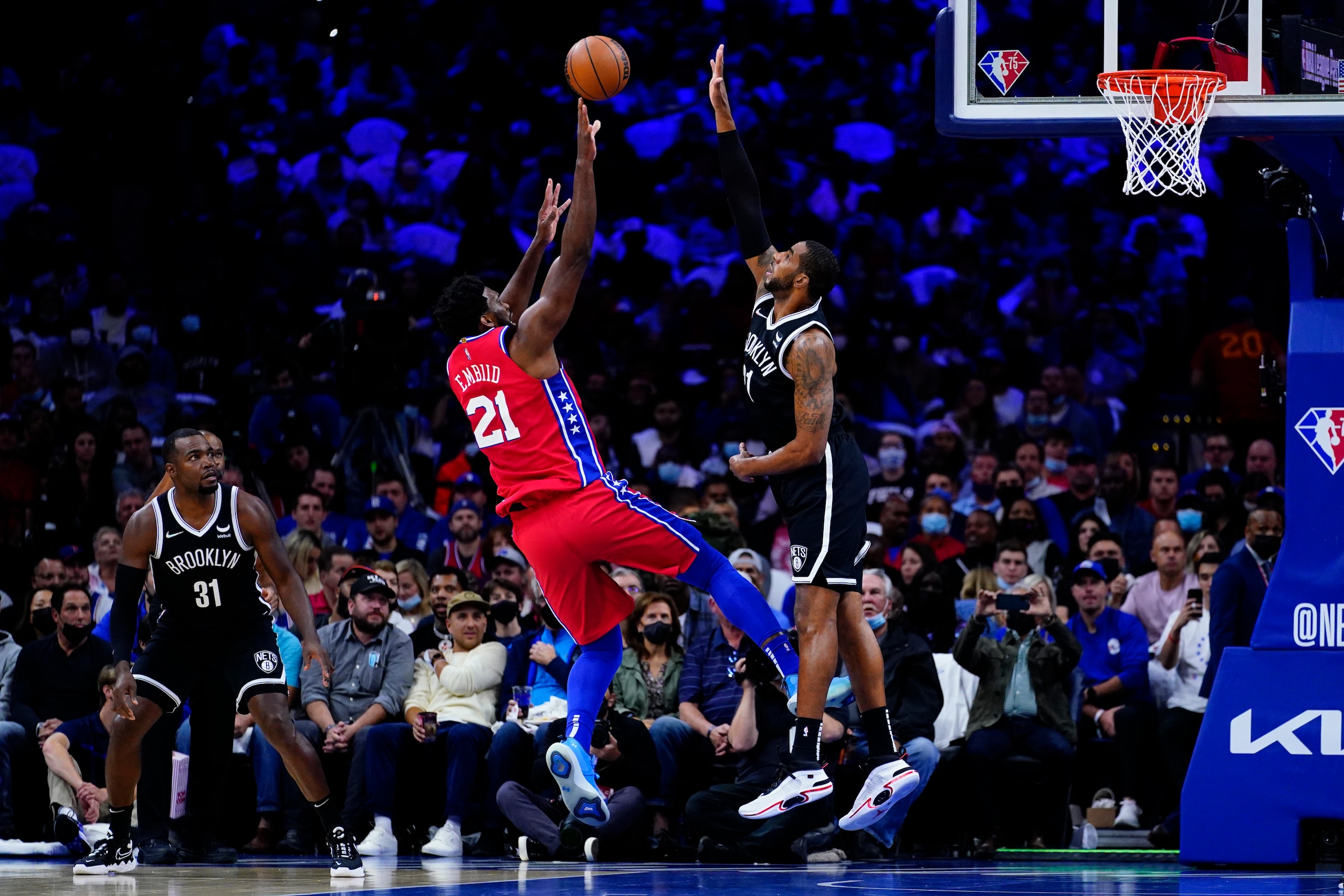 Philadelphia 76ers' Joel Embiid, center, goes up for a shot against Brooklyn Nets' LaMarcus Aldridge during the first half of an NBA basketball game, Friday, Oct. 22, 2021, in Philadelphia. (AP Photo/Matt Slocum)