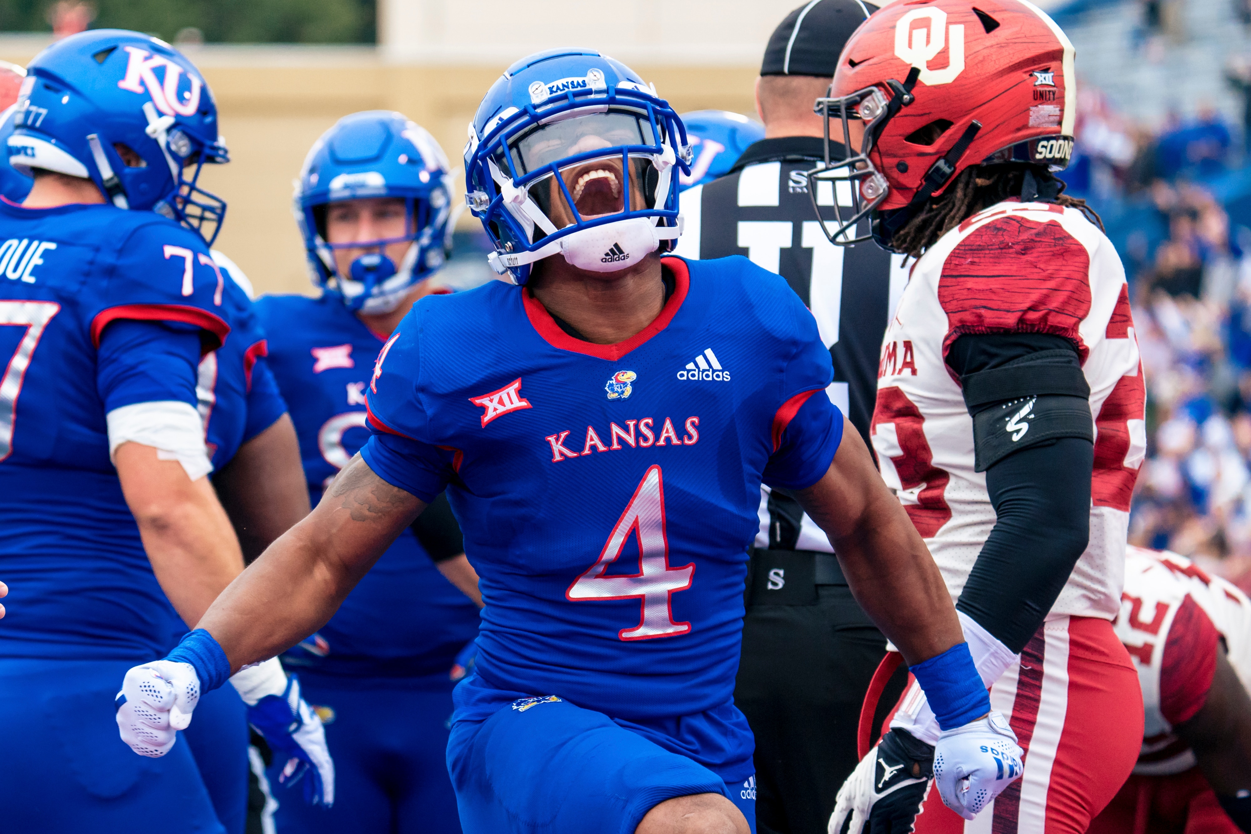 LAWRENCE, KS - OCTOBER 23: Devin Neal #4 of the Kansas Jayhawks celebrates after scoring a touchdown against the Oklahoma Sooners in the first quarter at David Booth Kansas Memorial Stadium on October 23, 2021 in Lawrence, Kansas. (Photo by Kyle Rivas/Getty Images)