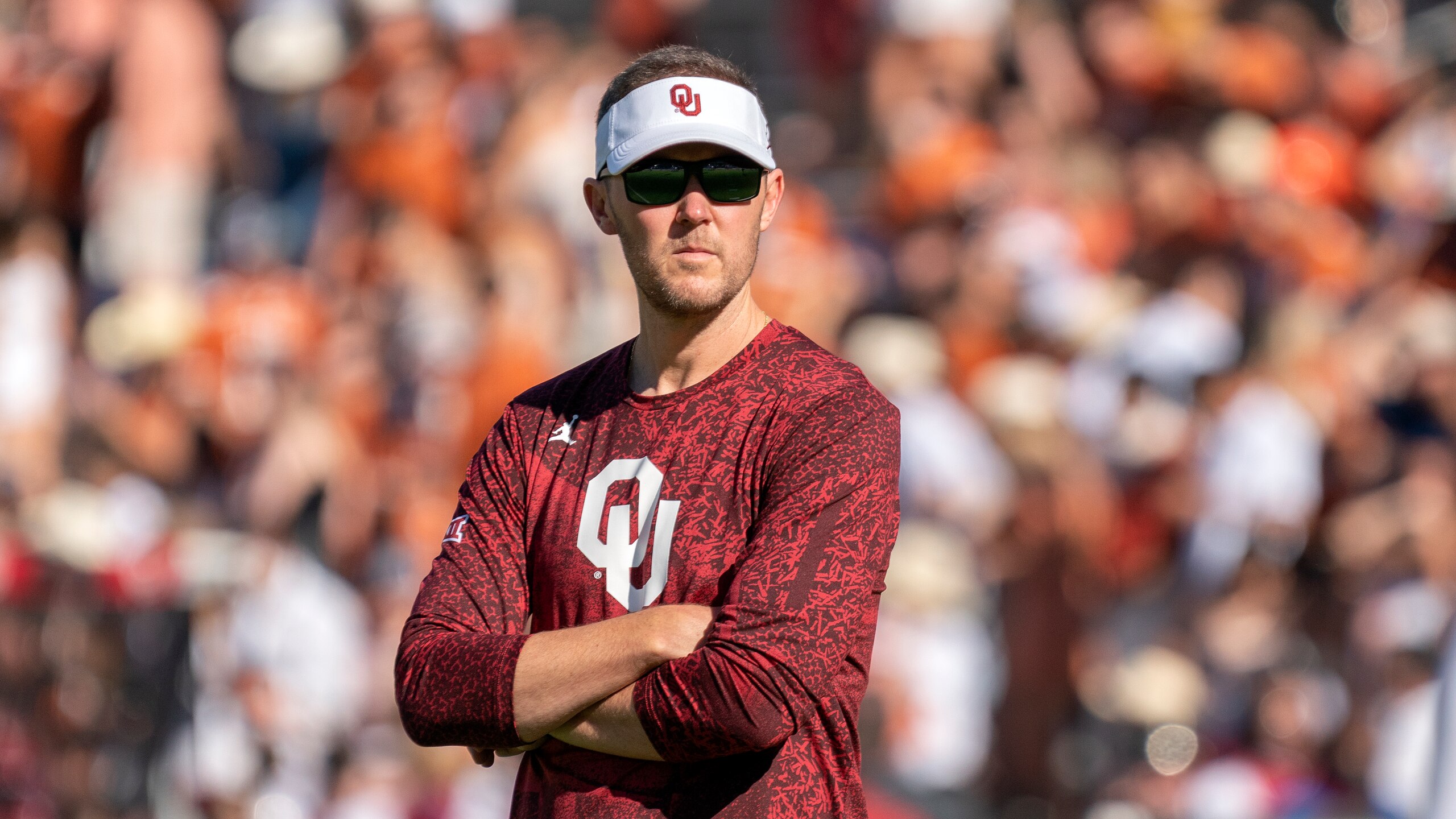 Oklahoma head coach Lincoln Riley watches his team warm up before an NCAA college football game against Texas at the Cotton Bowl, Saturday, Oct. 9, 2021, in Dallas. Oklahoma won 55-48. (AP Photo/Jeffrey McWhorter)
