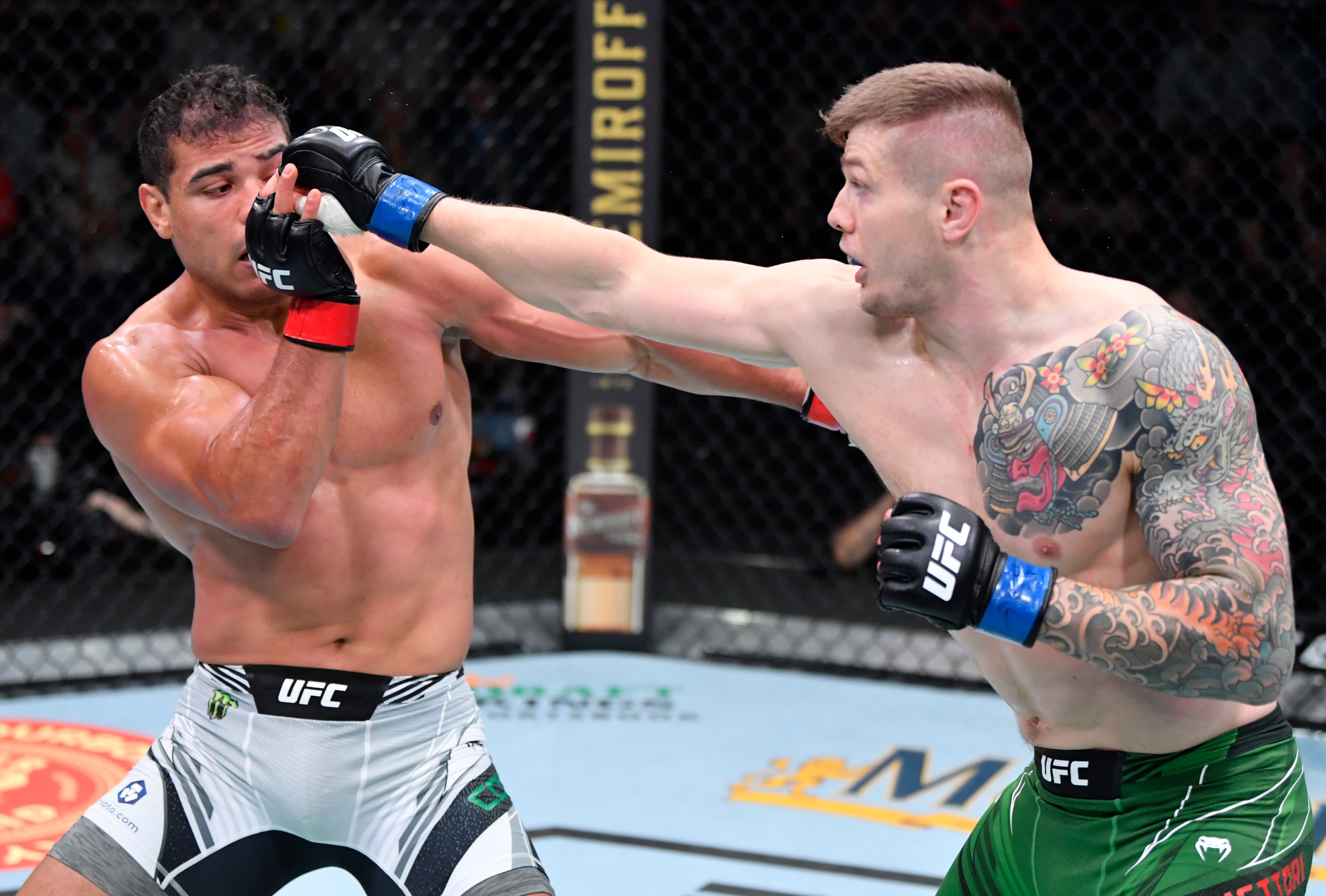 LAS VEGAS, NEVADA - OCTOBER 23: (R-L) Marvin Vettori of Italy punches Paulo Costa of Brazil in a light heavyweight fight during the UFC Fight Night event at UFC APEX on October 23, 2021 in Las Vegas, Nevada. (Photo by Jeff Bottari/Zuffa LLC)