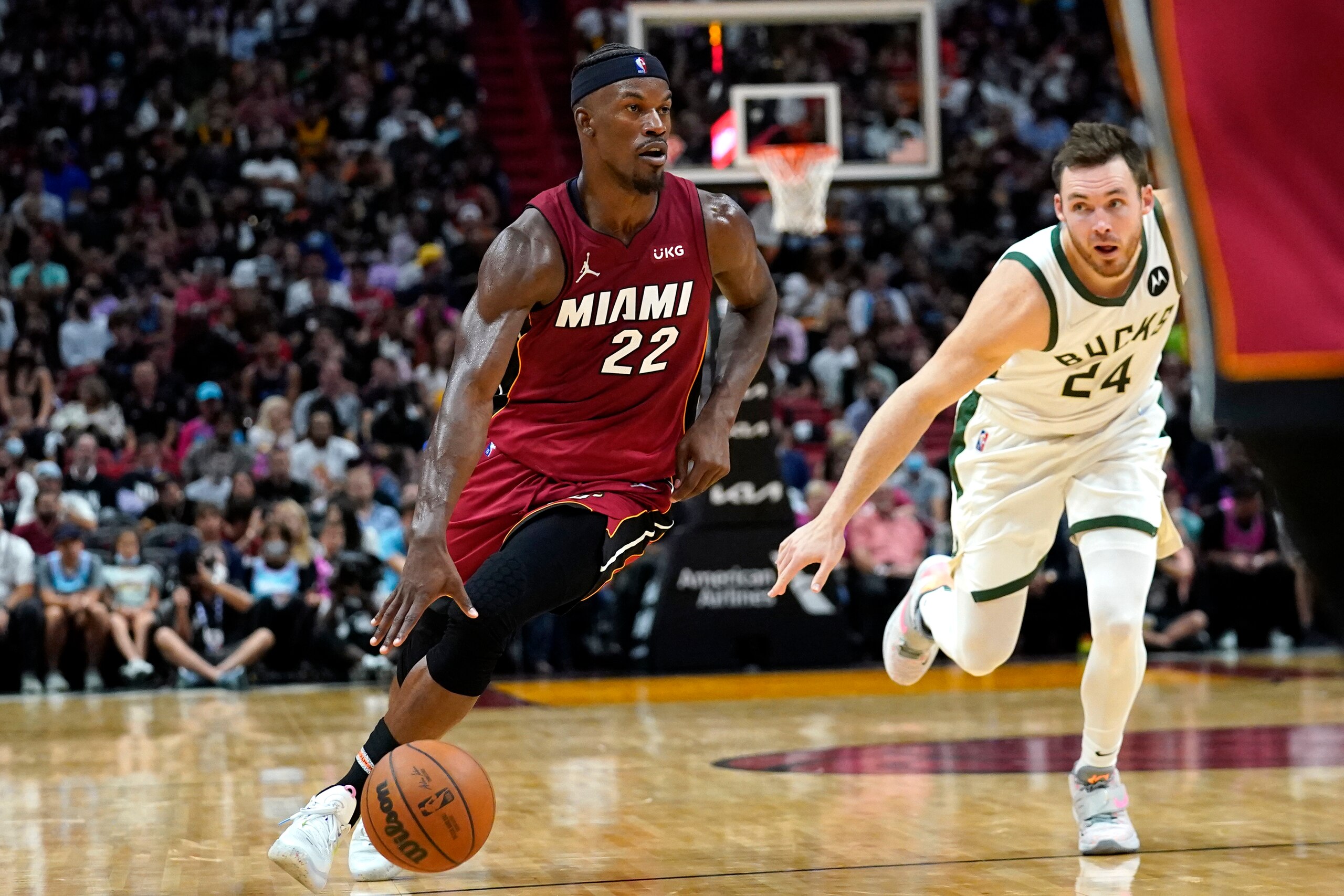 Miami Heat forward Jimmy Butler (22) drives to the basket as Milwaukee Bucks guard Pat Connaughton (24) defends during the second half of an NBA basketball game Thursday, Oct. 21, 2021, in Miami. The Heat won 137-95. (AP Photo/Lynne Sladky)