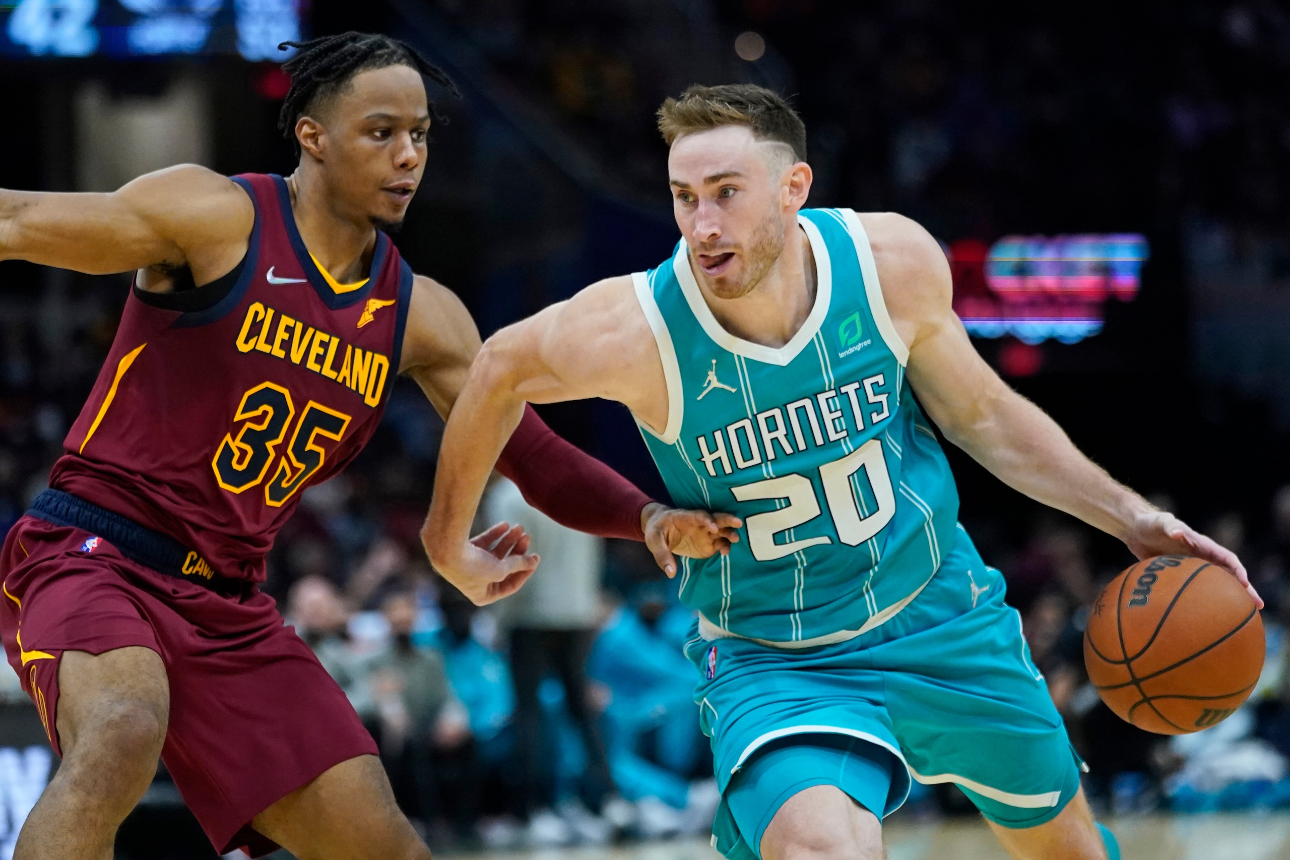 Charlotte Hornets' Gordon Hayward (20) drives against Cleveland Cavaliers' Isaac Okoro (35) in the second half of an NBA basketball game, Friday, Oct. 22, 2021, in Cleveland. (AP Photo/Tony Dejak)
