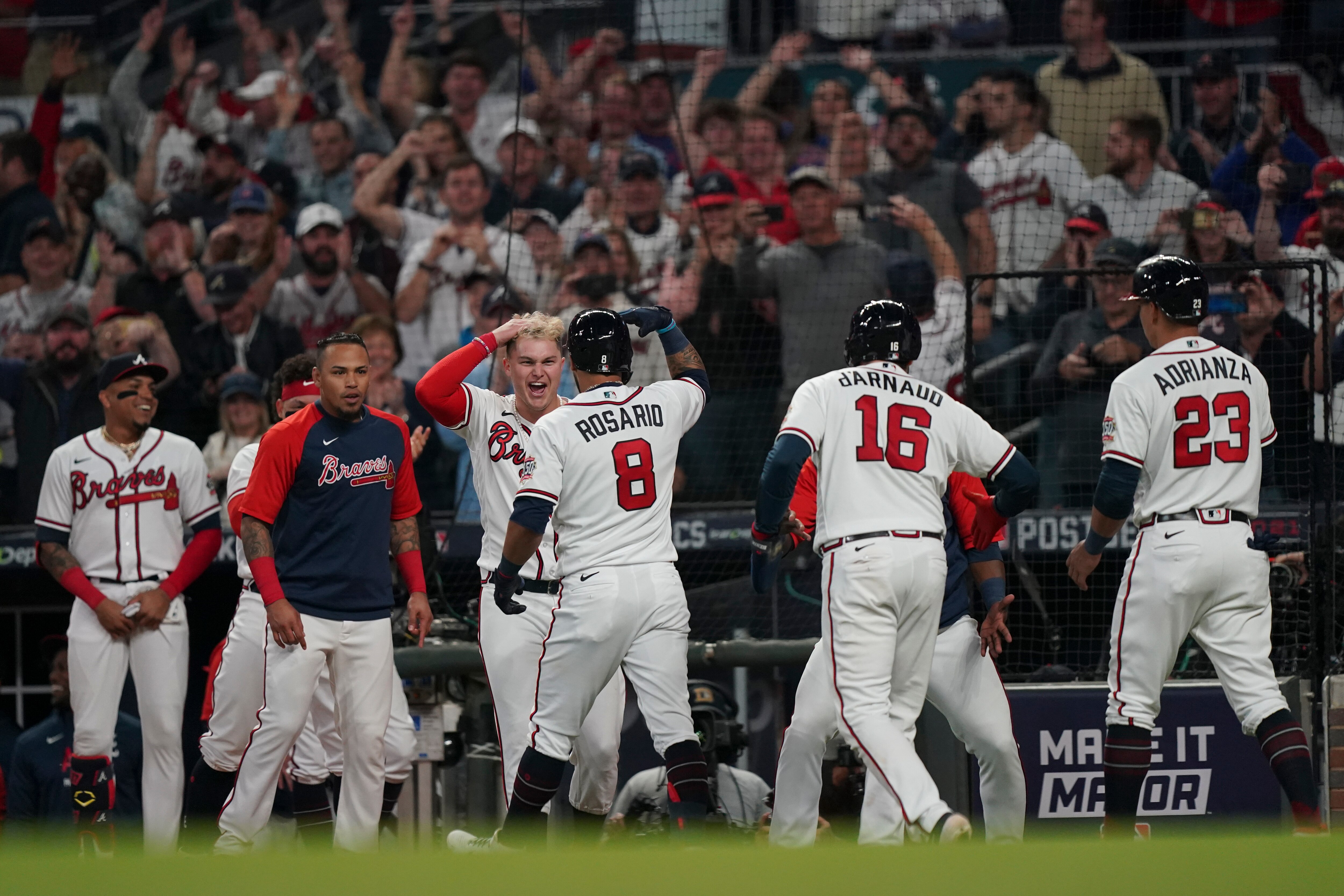 Atlanta Braves' Eddie Rosario (8) celebrates after hitting a three run home run during the fourth inning in Game 6 of baseball's National League Championship Series against the Los Angeles Dodgers Saturday, Oct. 23, 2021, in Atlanta. (AP Photo/Brynn Anderson)