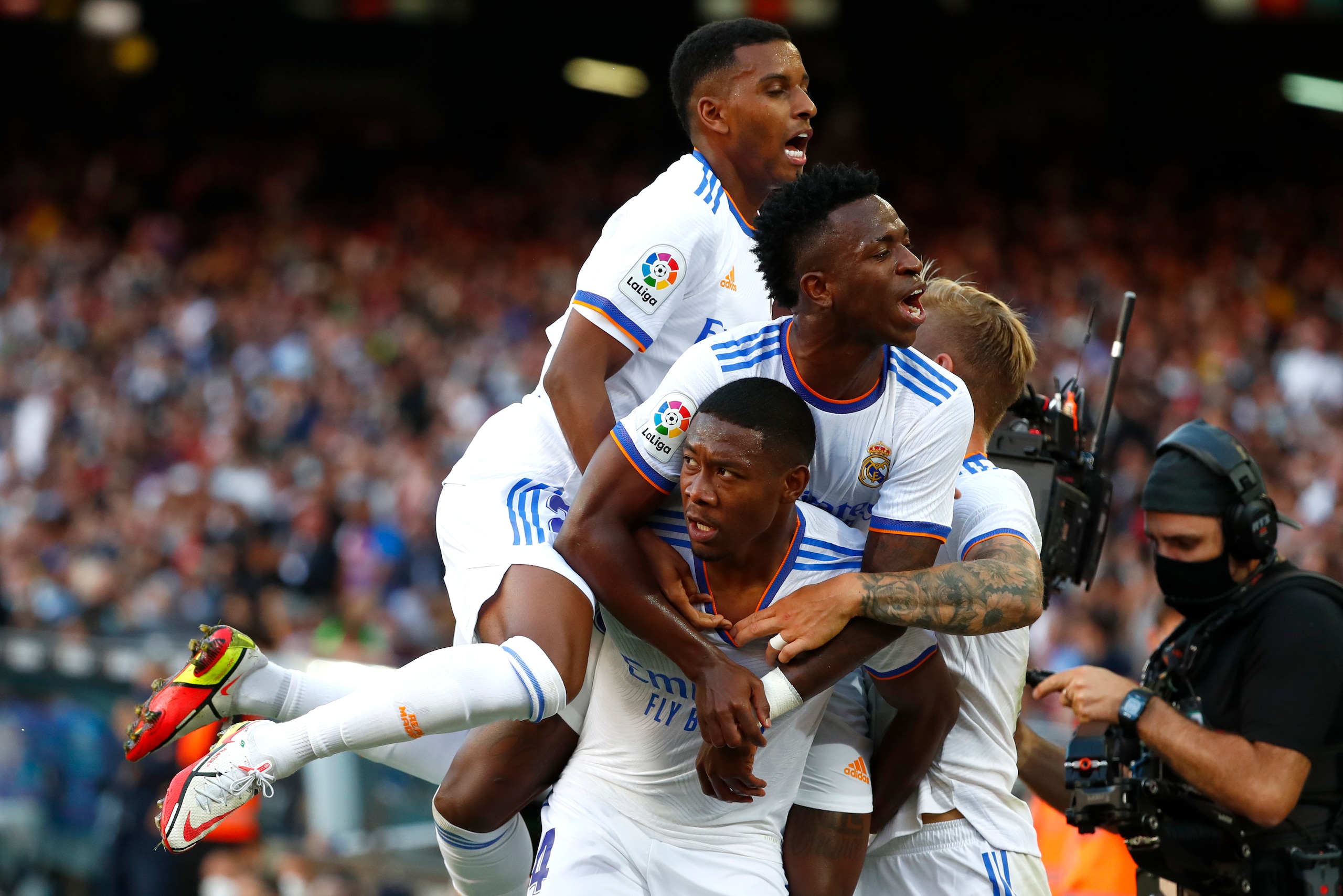 Real Madrid's David Alaba, down, celebrates with teammates after scoring his sides first goal during the Spanish La Liga soccer match between FC Barcelona and Real Madrid at the Camp Nou stadium in Barcelona, Spain, Sunday, Oct. 24, 2021. (AP Photo/Joan Monfort) Real Madrid's David Alaba, down, celebrates with teammates after scoring his sides first goal during the Spanish La Liga soccer match between FC Barcelona and Real Madrid at the Camp Nou stadium in Barcelona, Spain, Sunday, Oct. 24, 2021. (AP Photo/Joan Monfort)