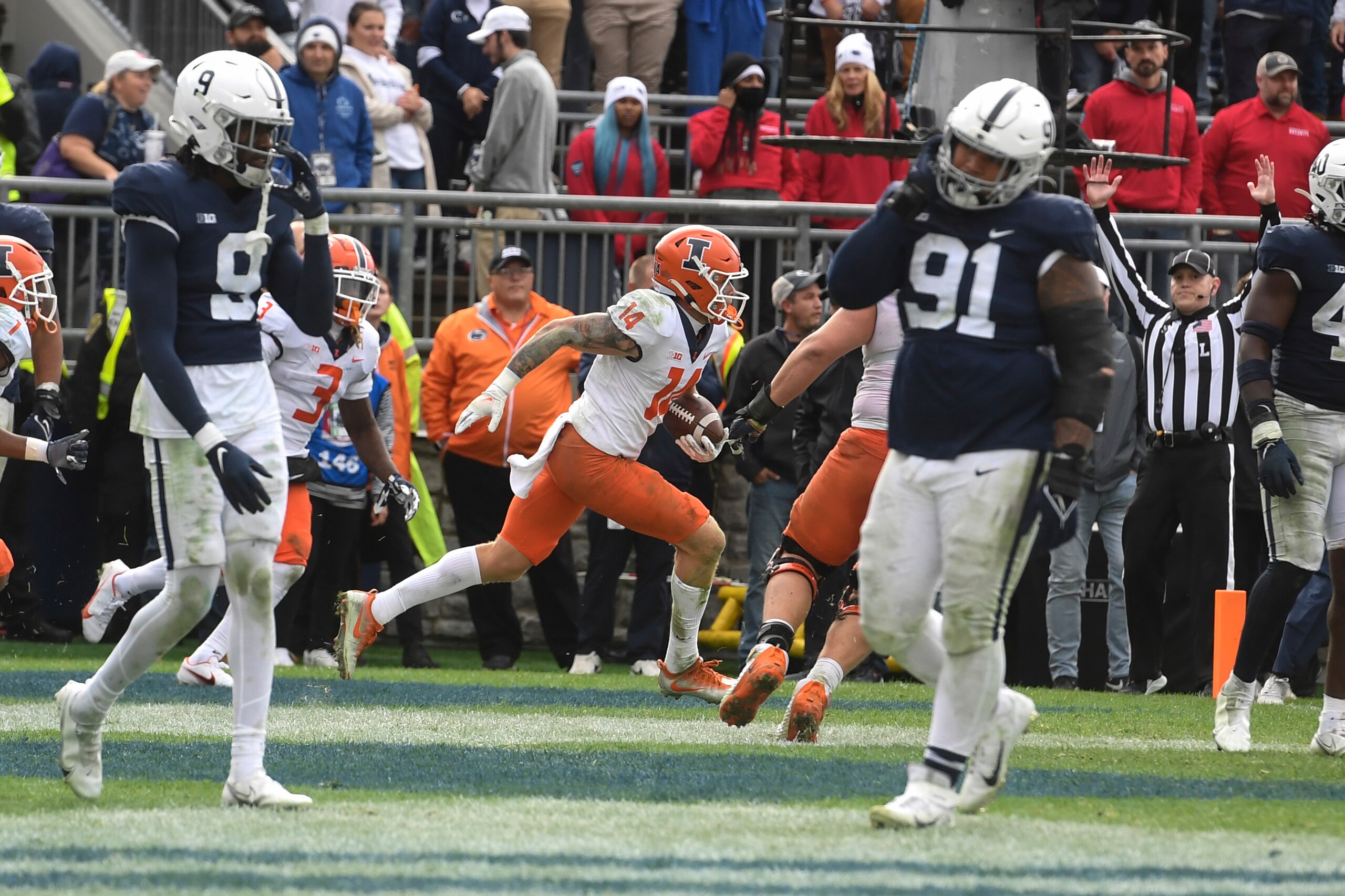 Illinois wide receiver Casey Washington (14) celebrates behind Penn State defenders Joey Porter Jr. (9) and Dvon Ellies (91) after catching a pass for a 2-point conversion in the ninth overtime to defeat Penn State 20-18 in an NCAA college football game in State College, Pa., Saturday, Oct. 23, 2021. (AP Photo/Barry Reeger)