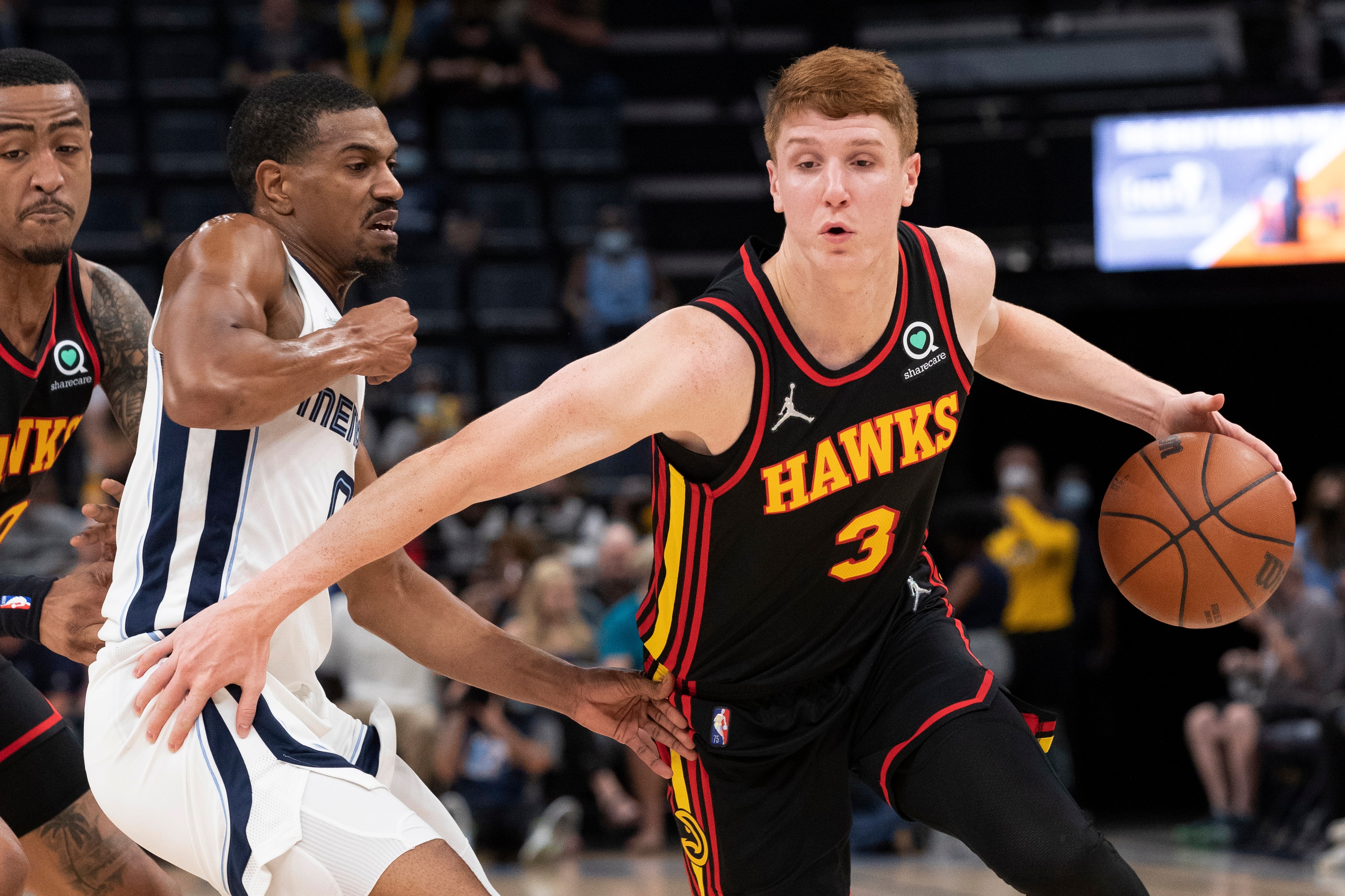 Atlanta Hawks guard Kevin Huerter (3) drives to the basket against the defense of Memphis Grizzlies guard De'Anthony Melton (left) in the first half of a preseason NBA basketball game Saturday, Oct. 9, 2021, in Memphis, Tenn. (AP Photo/Nikki Boertman)