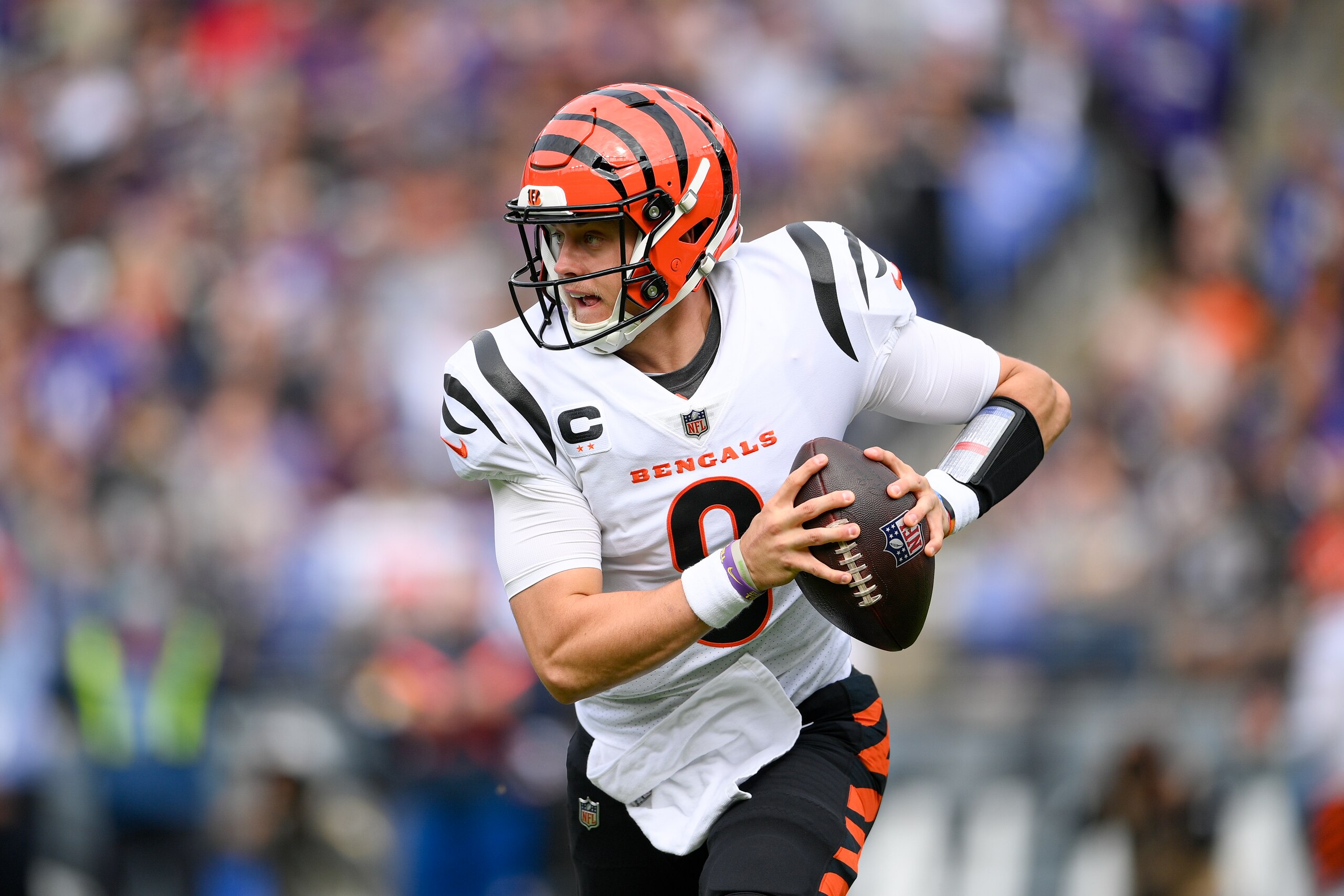Cincinnati Bengals quarterback Joe Burrow rolls out to pass against the Baltimore Ravens during the first half of an NFL football game, Sunday, Oct. 24, 2021, in Baltimore. (AP Photo/Nick Wass)