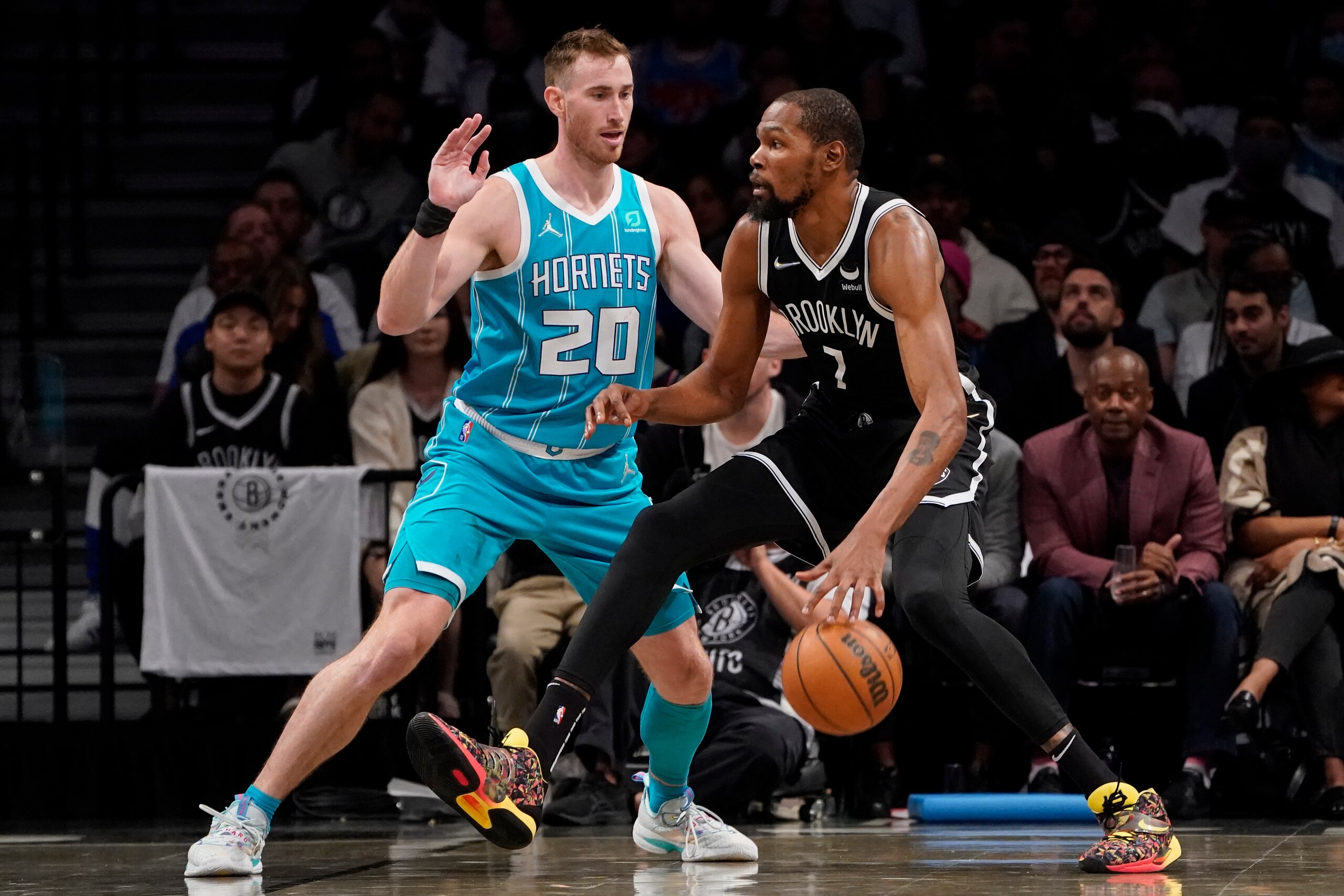 Brooklyn Nets forward Kevin Durant, right, drives against Charlotte Hornets forward Gordon Hayward (20) during the first half of an NBA basketball game, Sunday, Oct. 24, 2021, in New York. (AP Photo/John Minchillo)
