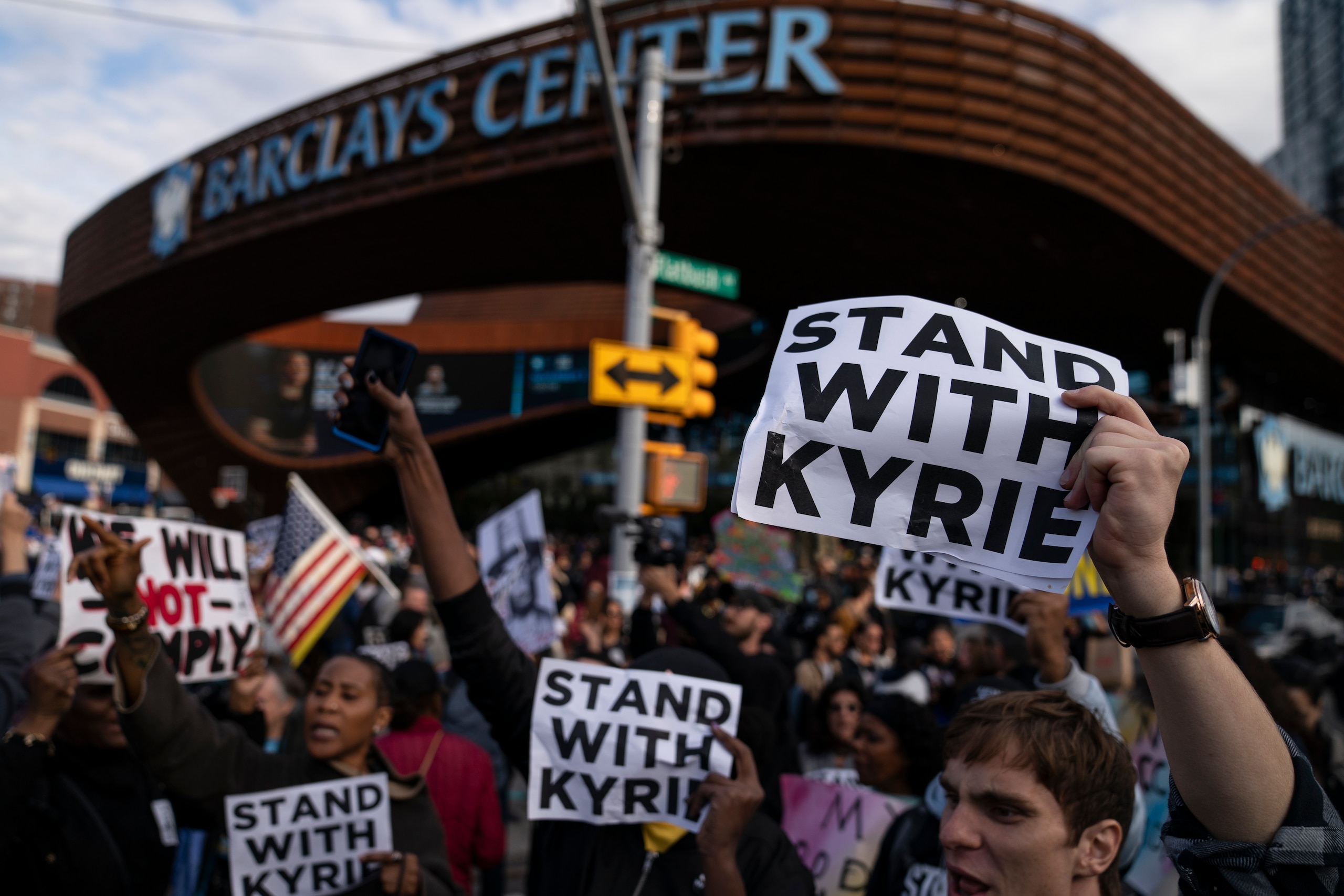 Protesters rallying against COVID-19 vaccination mandates and in support of basketball player Kyrie Irving gather in the street outside the Barclays Center before an NBA basketball game between the Brooklyn Nets and the Charlotte Hornets, Sunday, Oct. 24, 2021, in New York. (AP Photo/John Minchillo)