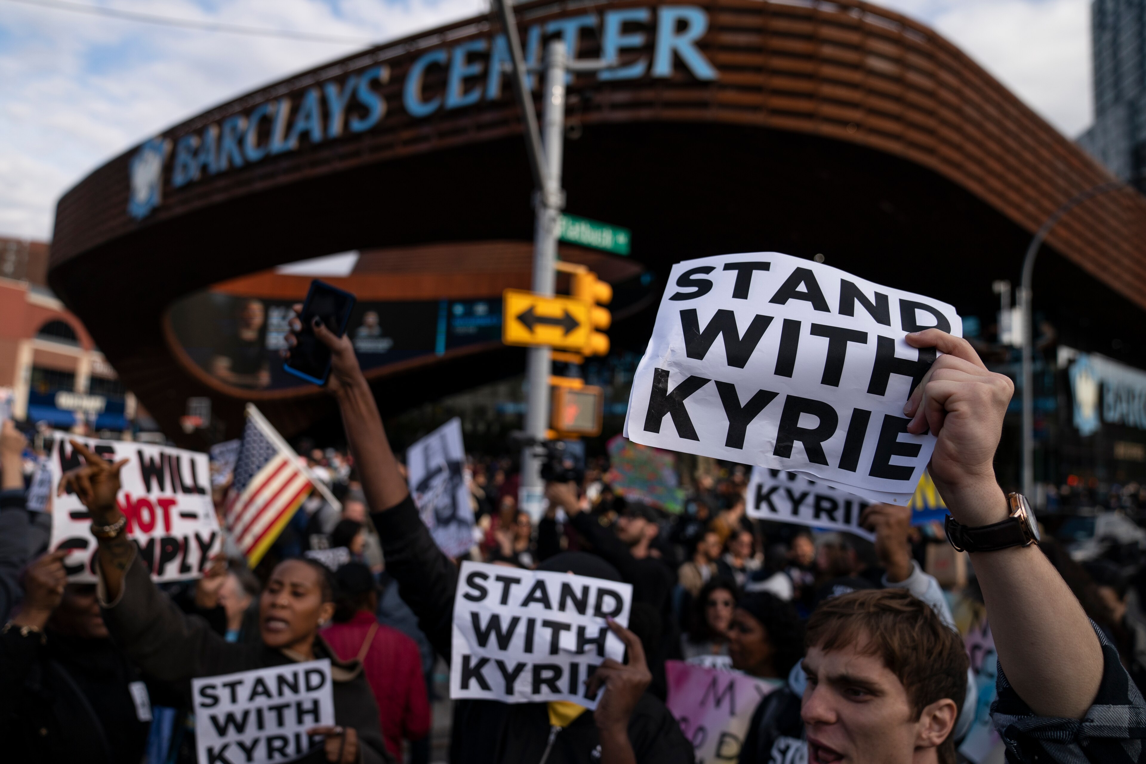 Protesters rallying against COVID-19 vaccination mandates and in support of basketball player Kyrie Irving gather in the street outside the Barclays Center before an NBA basketball game between the Brooklyn Nets and the Charlotte Hornets, Sunday, Oct. 24, 2021, in New York. (AP Photo/John Minchillo) Protesters rallying against COVID-19 vaccination mandates and in support of basketball player Kyrie Irving gather in the street outside the Barclays Center before an NBA basketball game between the Brooklyn Nets and the Charlotte Hornets, Sunday, Oct. 24, 2021, in New York. (AP Photo/John Minchillo)