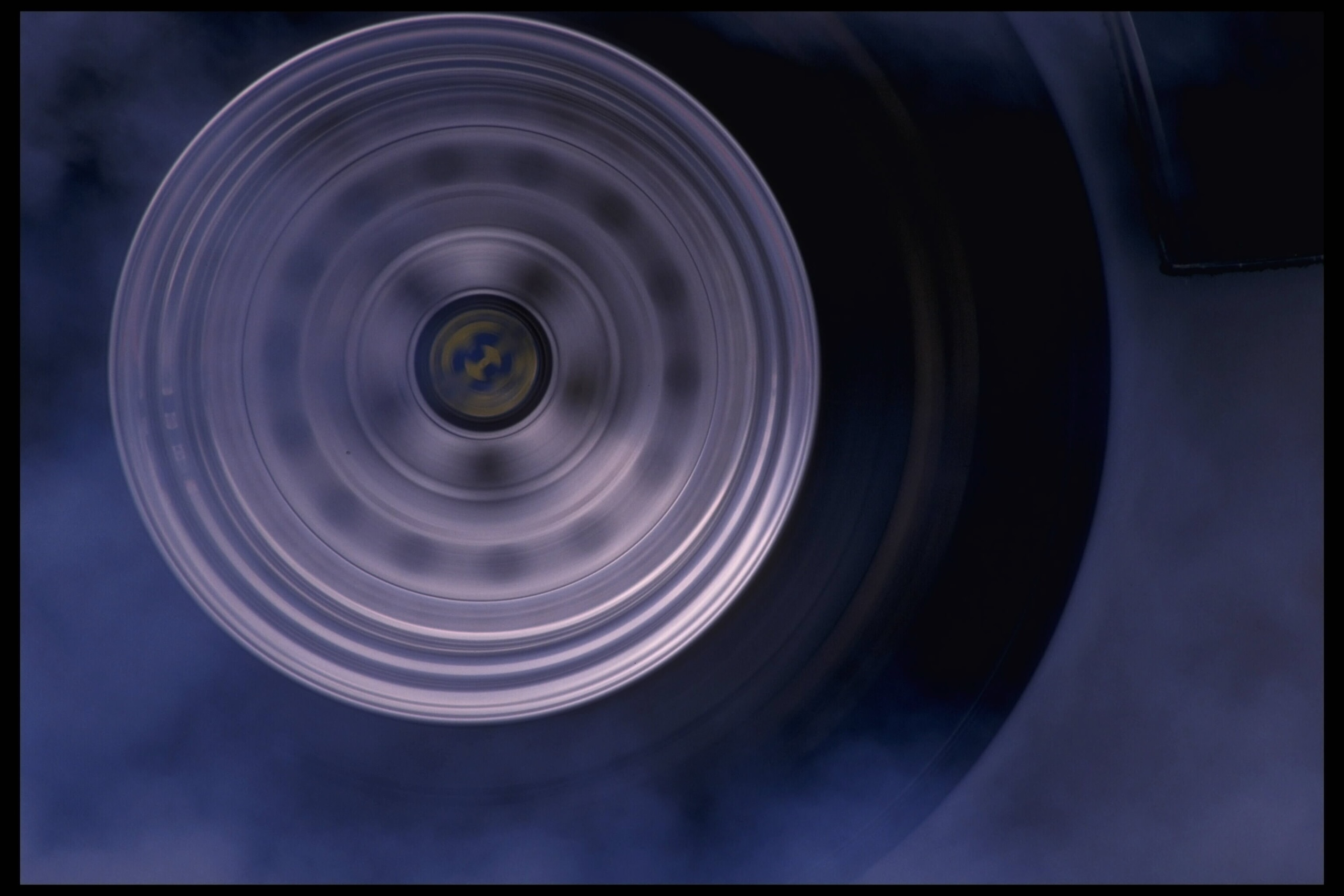 Portrait of a drag car's wheel as it starts its turning at the National Hot Rod Association Winternationals at Pomona Dragway in Pomona, California.