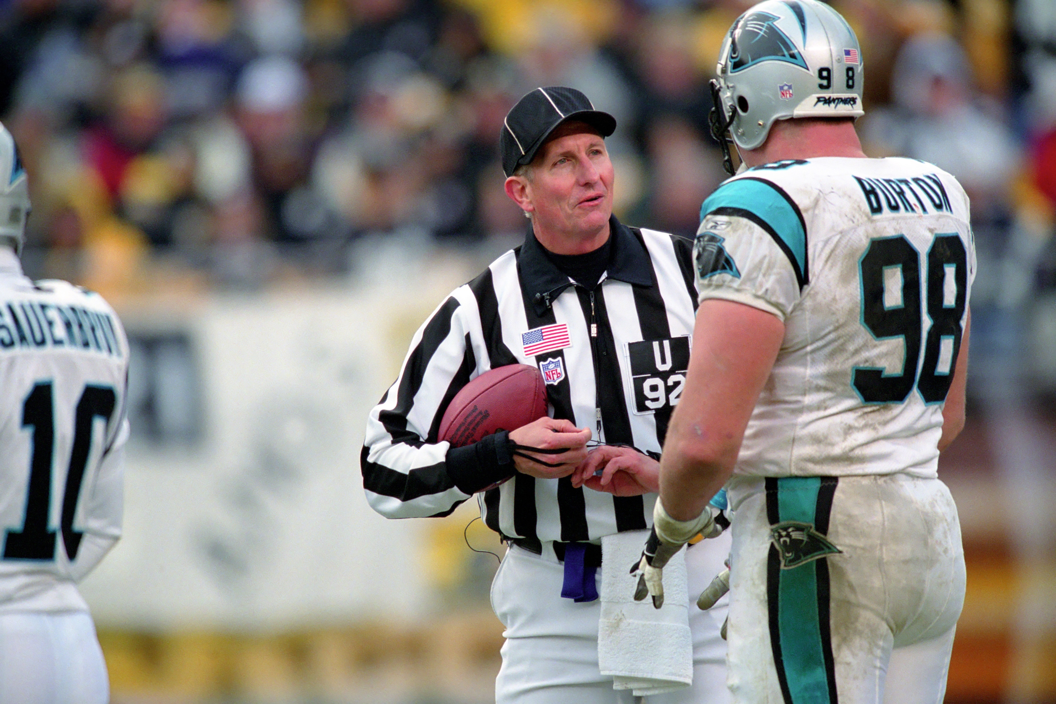 PITTSBURGH - DECEMBER 15:  National Football League umpire Carl Madsen #92 talks with defensive lineman Shane Burton #98 of the Carolina Panthers during a game against the Pittsburgh Steelers at Heinz Field on December 15, 2002 in Pittsburgh, Pennsylvania.  (Photo by George Gojkovich/Getty Images)
