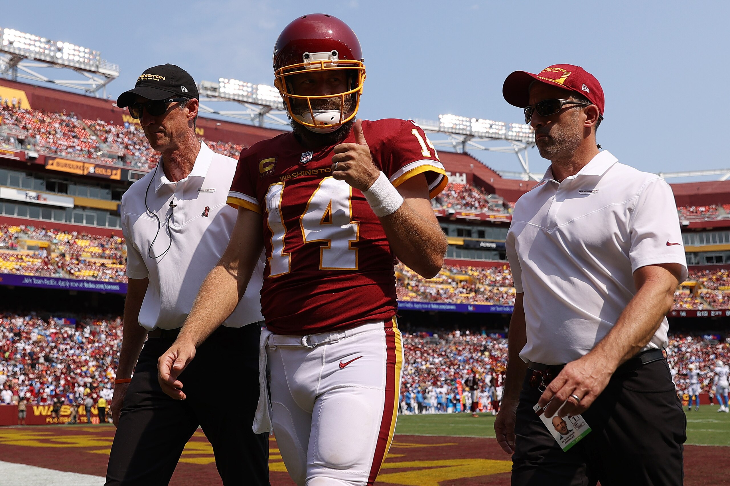 LANDOVER, MARYLAND - SEPTEMBER 12: Ryan Fitzpatrick #14 of the Washington Football Team reacts as he is taken off the field after being injured against the Los Angeles Chargers during the second quarter at FedExField on September 12, 2021 in Landover, Maryland. (Photo by Patrick Smith/Getty Images)