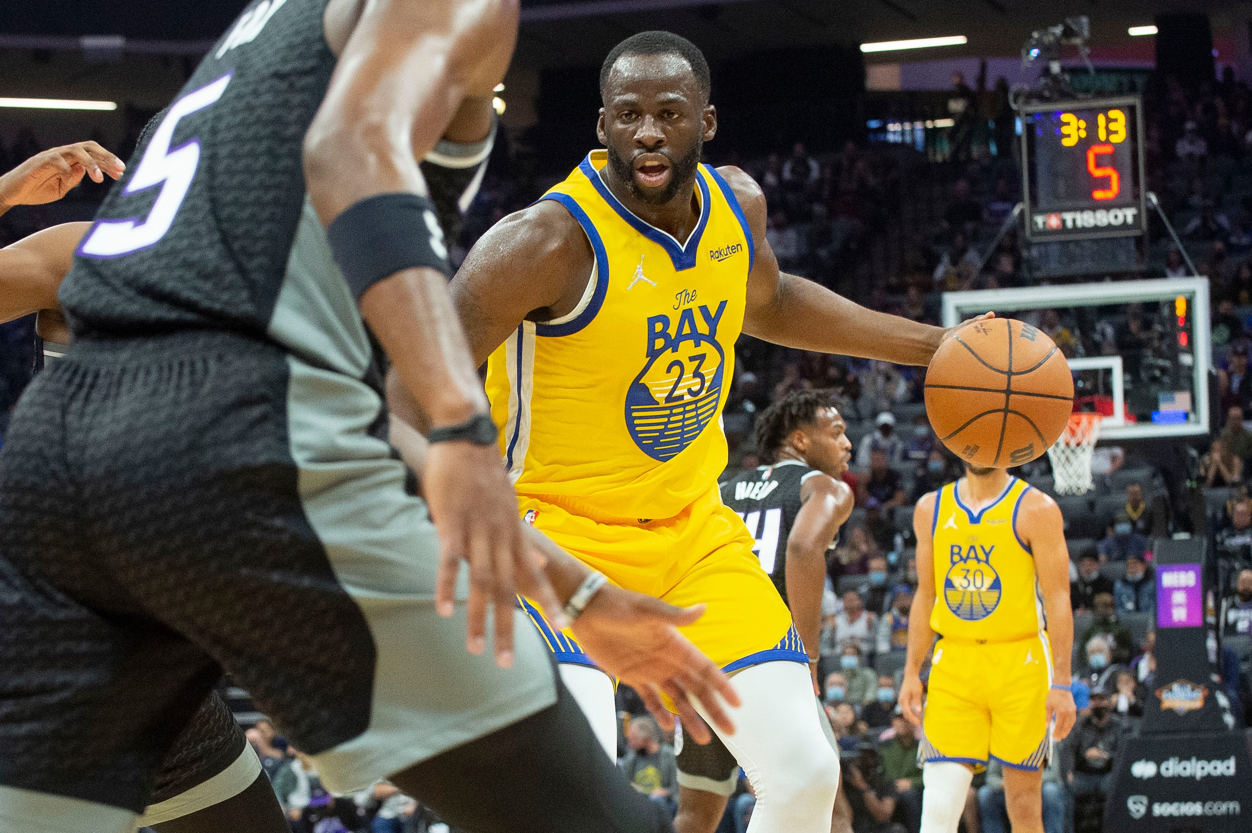 Golden State Warriors forward Draymond Green (23) works the ball against Sacramento Kings defenders during the first quarter of an NBA basketball game in Sacramento, Calif., Sunday, Oct. 24, 2021. (AP Photo/Randall Benton) Golden State Warriors forward Draymond Green (23) works the ball against Sacramento Kings defenders during the first quarter of an NBA basketball game in Sacramento, Calif., Sunday, Oct. 24, 2021. (AP Photo/Randall Benton)