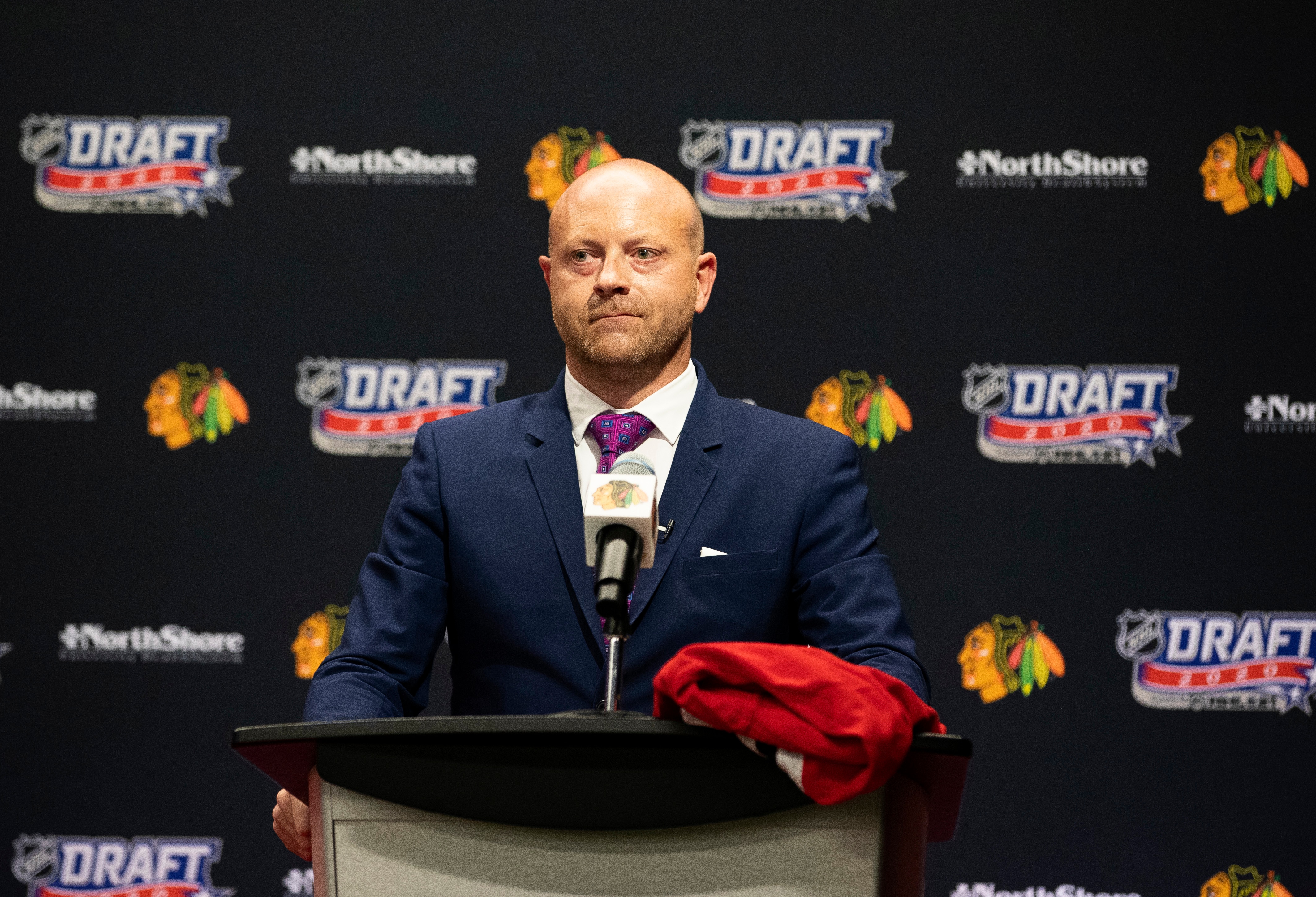 CHICAGO, ILLINOIS - OCTOBER 06: Vice president and general manager Stan Bowman of the Chicago Blackhawks speaks from the podium before their 17th overall pick in the first round of the 2020 NHL Entry Draft at Fifth Third Arena on October 06, 2020 in Chicago, Illinois. The 2020 NHL Draft was held virtually due to the ongoing Coronavirus pandemic. (Photo by Taylor Wilder/NHLI via Getty Images)
