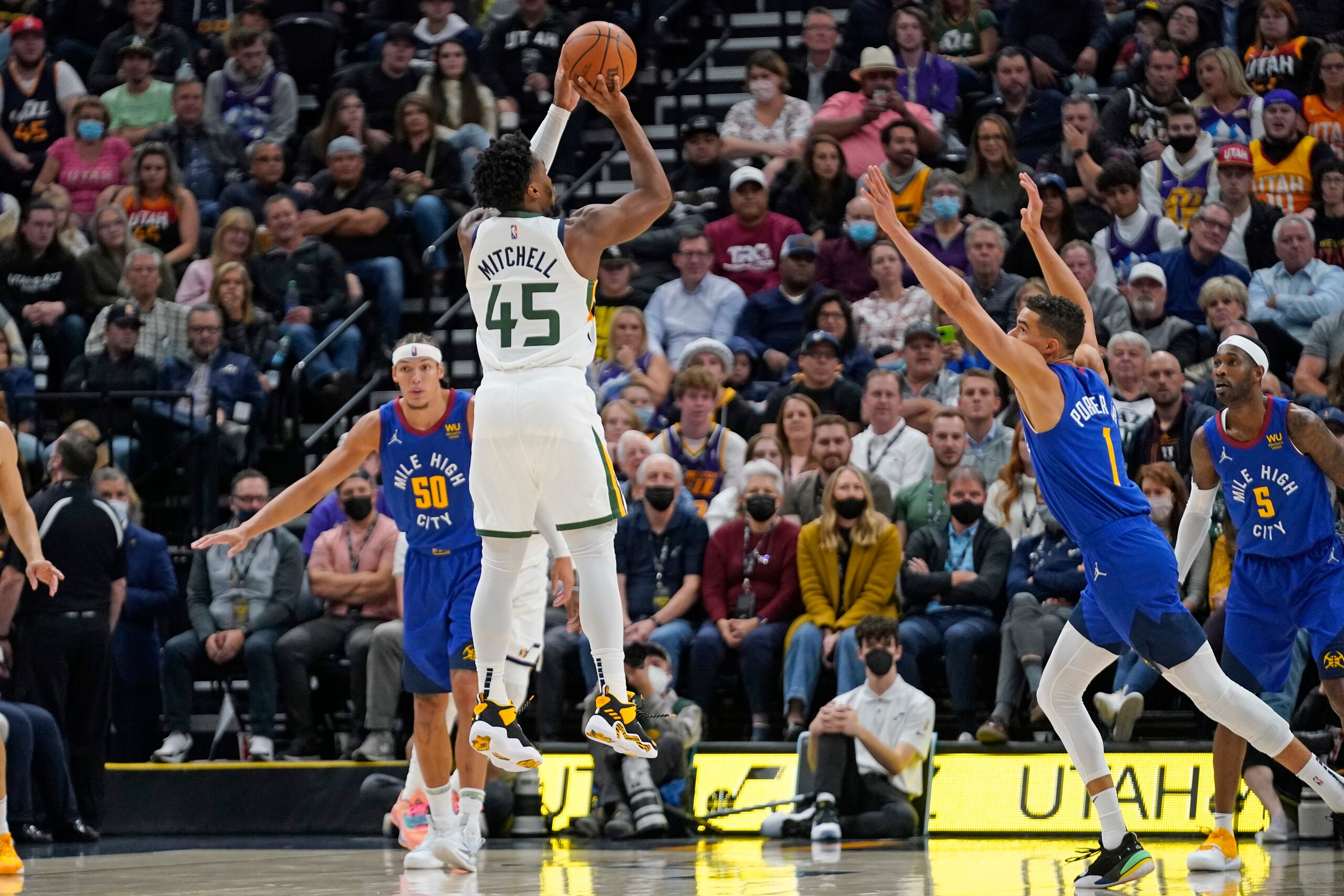 Utah Jazz guard Donovan Mitchell (45) shoots as Denver Nuggets forward Michael Porter Jr. (1) defends in the first half during an NBA basketball game Tuesday, Oct. 26, 2021, in Salt Lake City. (AP Photo/Rick Bowmer) Utah Jazz guard Donovan Mitchell (45) shoots as Denver Nuggets forward Michael Porter Jr. (1) defends in the first half during an NBA basketball game Tuesday, Oct. 26, 2021, in Salt Lake City. (AP Photo/Rick Bowmer)