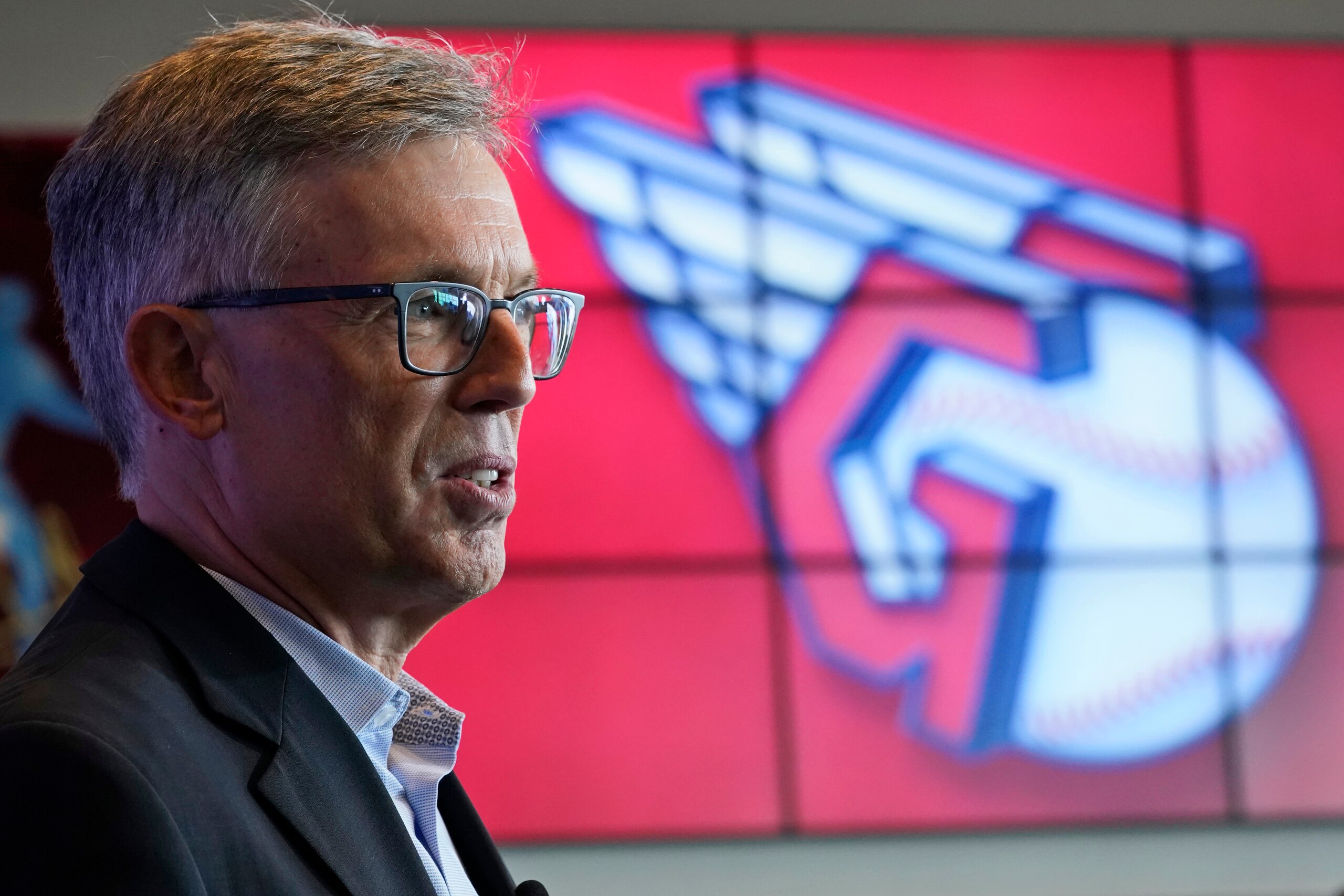 Cleveland Indians owner Paul Dolan speaks to the media as the new Indians logo is displayed, Friday, July 23, 2021, in Cleveland. Known as the Indians since 1915, Cleveland's Major League Baseball team will be called Guardians. The ballclub announced the name change Friday, effective at the end of the 2021 season. (AP Photo/Tony Dejak) Cleveland Indians owner Paul Dolan speaks to the media as the new Indians logo is displayed, Friday, July 23, 2021, in Cleveland. Known as the Indians since 1915, Cleveland's Major League Baseball team will be called Guardians. The ballclub announced the name change Friday, effective at the end of the 2021 season. (AP Photo/Tony Dejak)