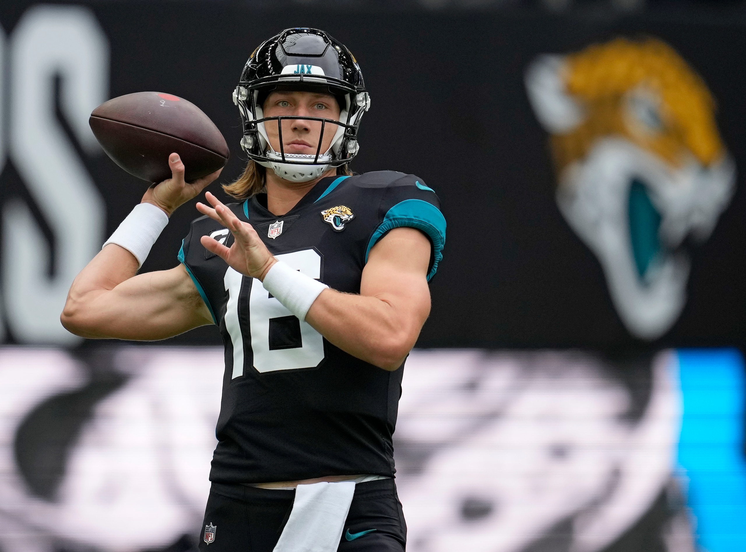Jacksonville Jaguars quarterback Trevor Lawrence (16) prepares to pass the ball as he warms-up before an NFL football game between the Miami Dolphins and the Jacksonville Jaguars at the Tottenham Hotspur stadium in London, England, Sunday, Oct. 17, 2021. (AP Photo/Matt Dunham)