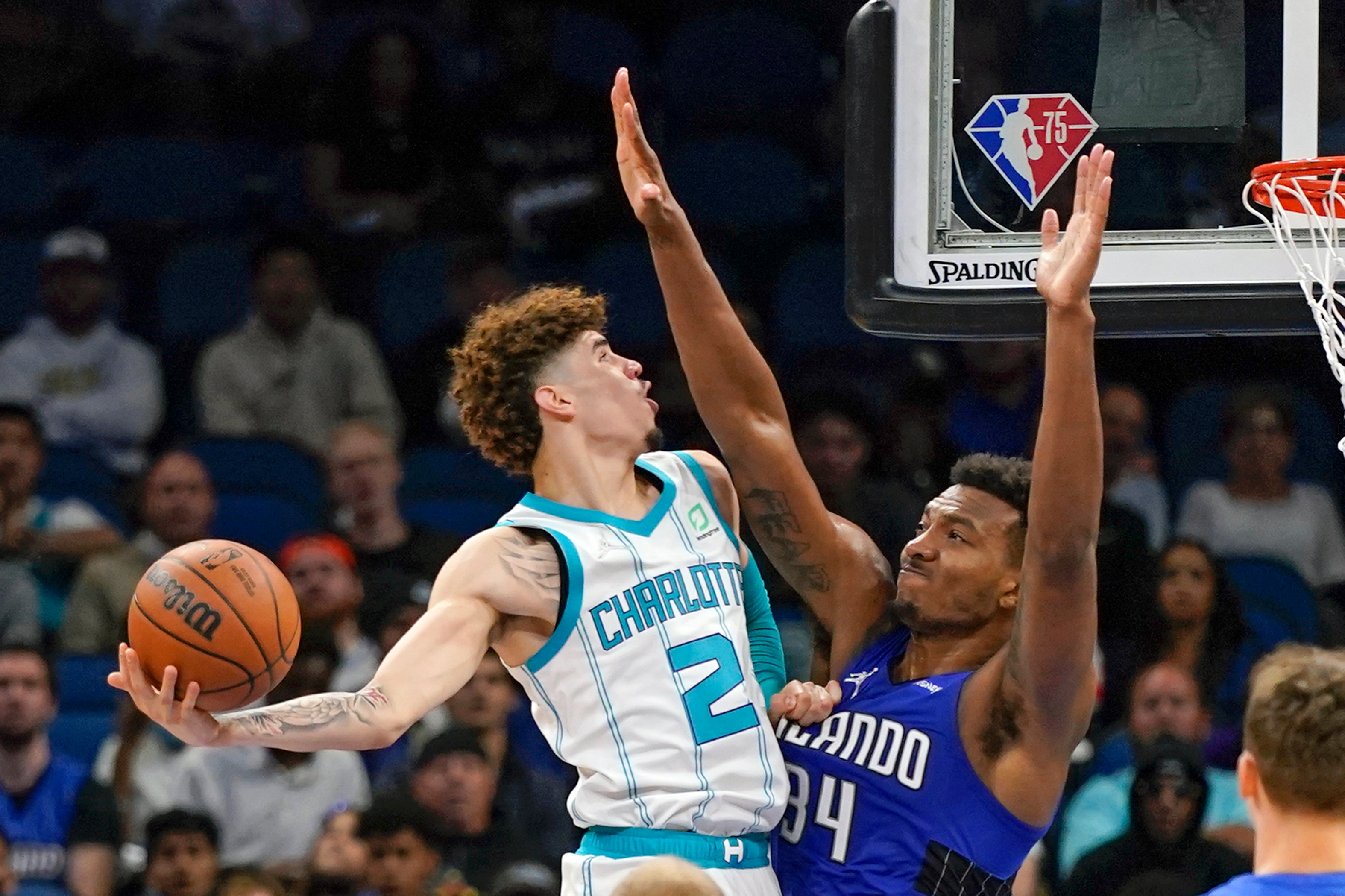 Orlando Magic's Wendell Carter Jr., right, goes up to stop Charlotte Hornets' LaMelo Ball (2) from making a shot during the second half of an NBA basketball game, Wednesday, Oct. 27, 2021, in Orlando, Fla. (AP Photo/John Raoux)