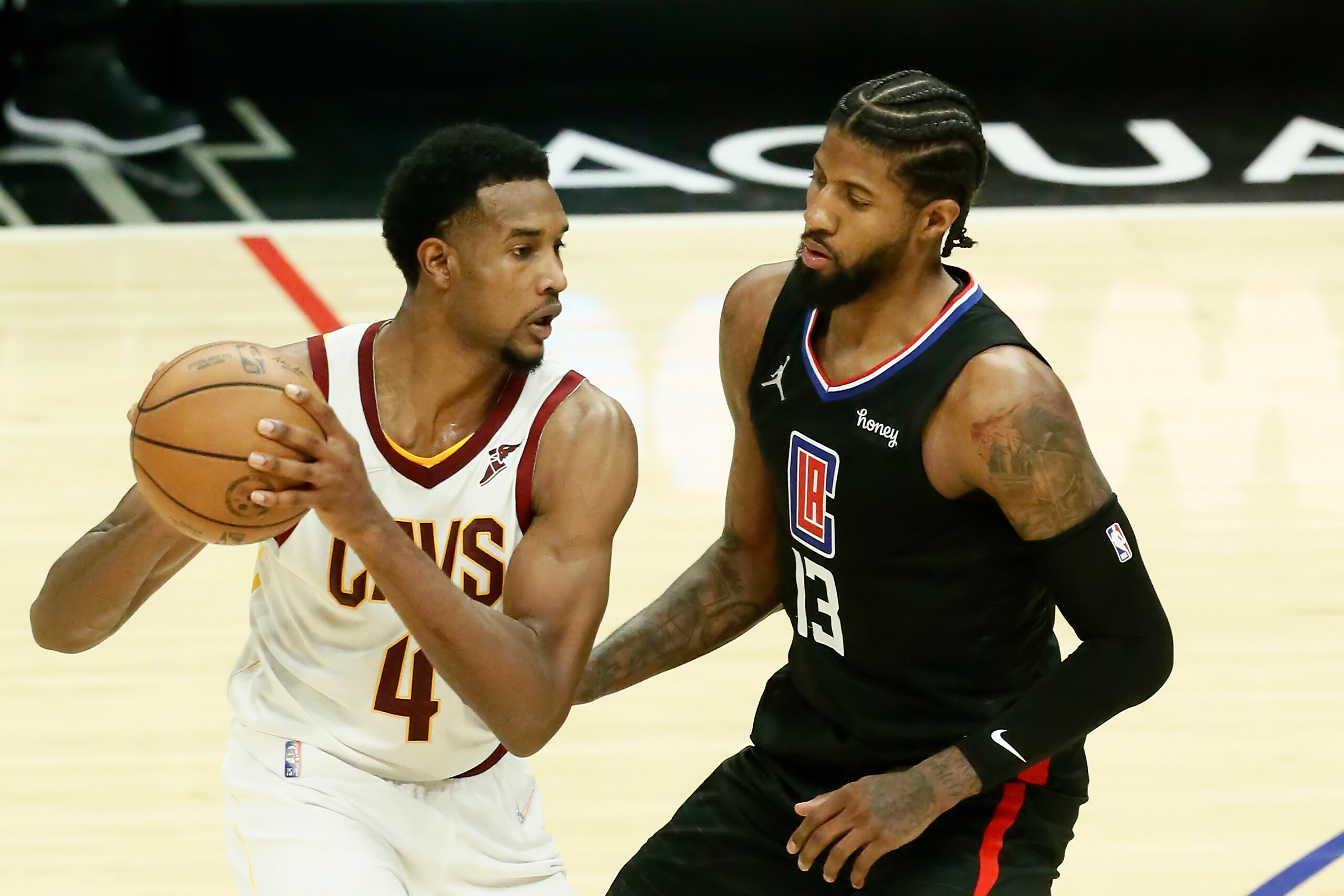 LOS ANGELES, CA - OCTOBER 27: Paul George #13 of the LA Clippers plays defense on Evan Mobley #4 of the Cleveland Cavaliers during a game at the STAPLES Center on October 27, 2021 in Los Angeles, California. NOTE TO USER: User expressly acknowledges and agrees that, by downloading and or using this photograph, User is consenting to the terms and conditions of the Getty Images License Agreement. Mandatory Credit: 2021 NBAE (Photo by Chris Elise/NBAE via Getty Images)