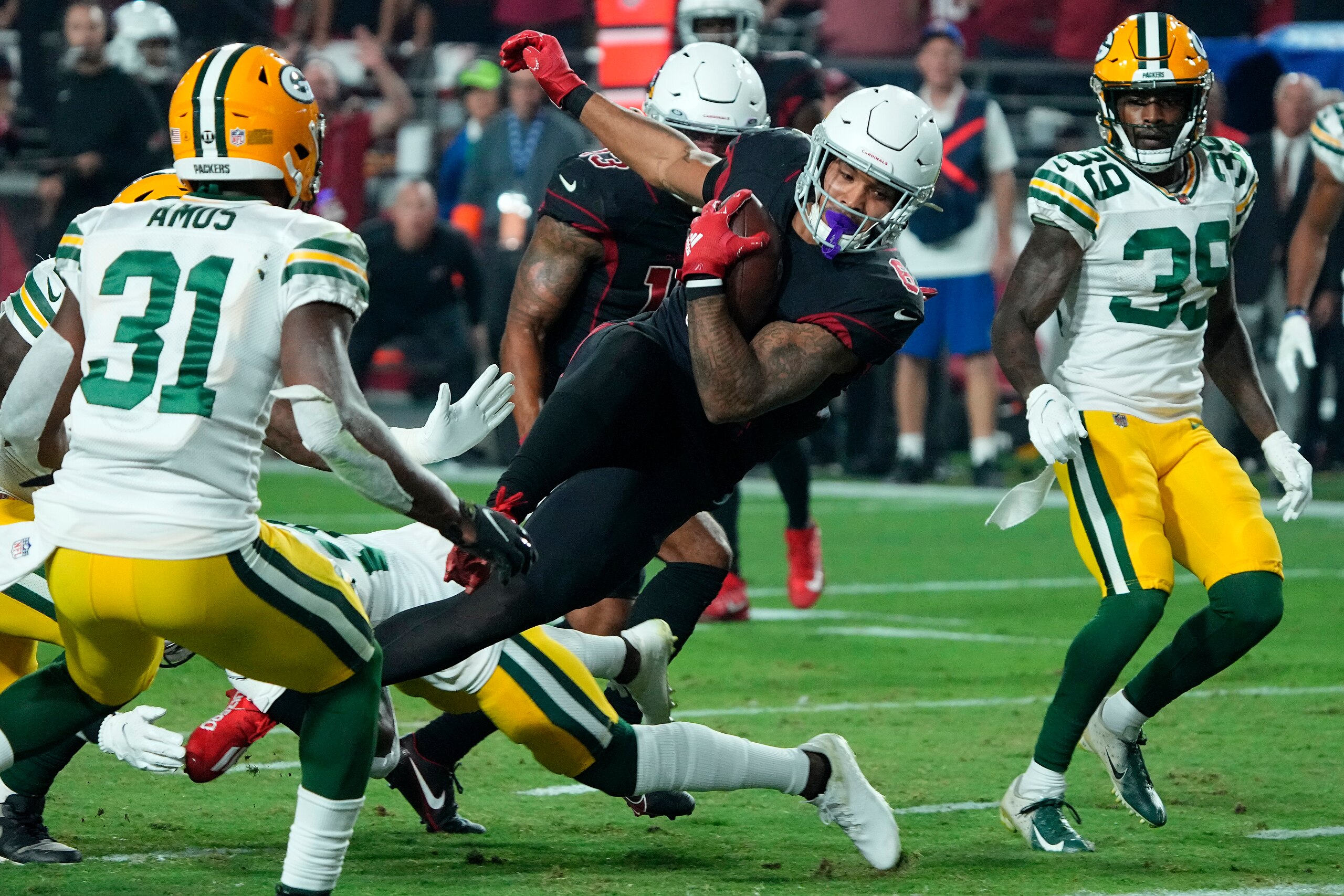 Arizona Cardinals running back James Conner (6) scores a touchdown against the Green Bay Packers during the second half of an NFL football game, Thursday, Oct. 28, 2021, in Glendale, Ariz. (AP Photo/Rick Scuteri)