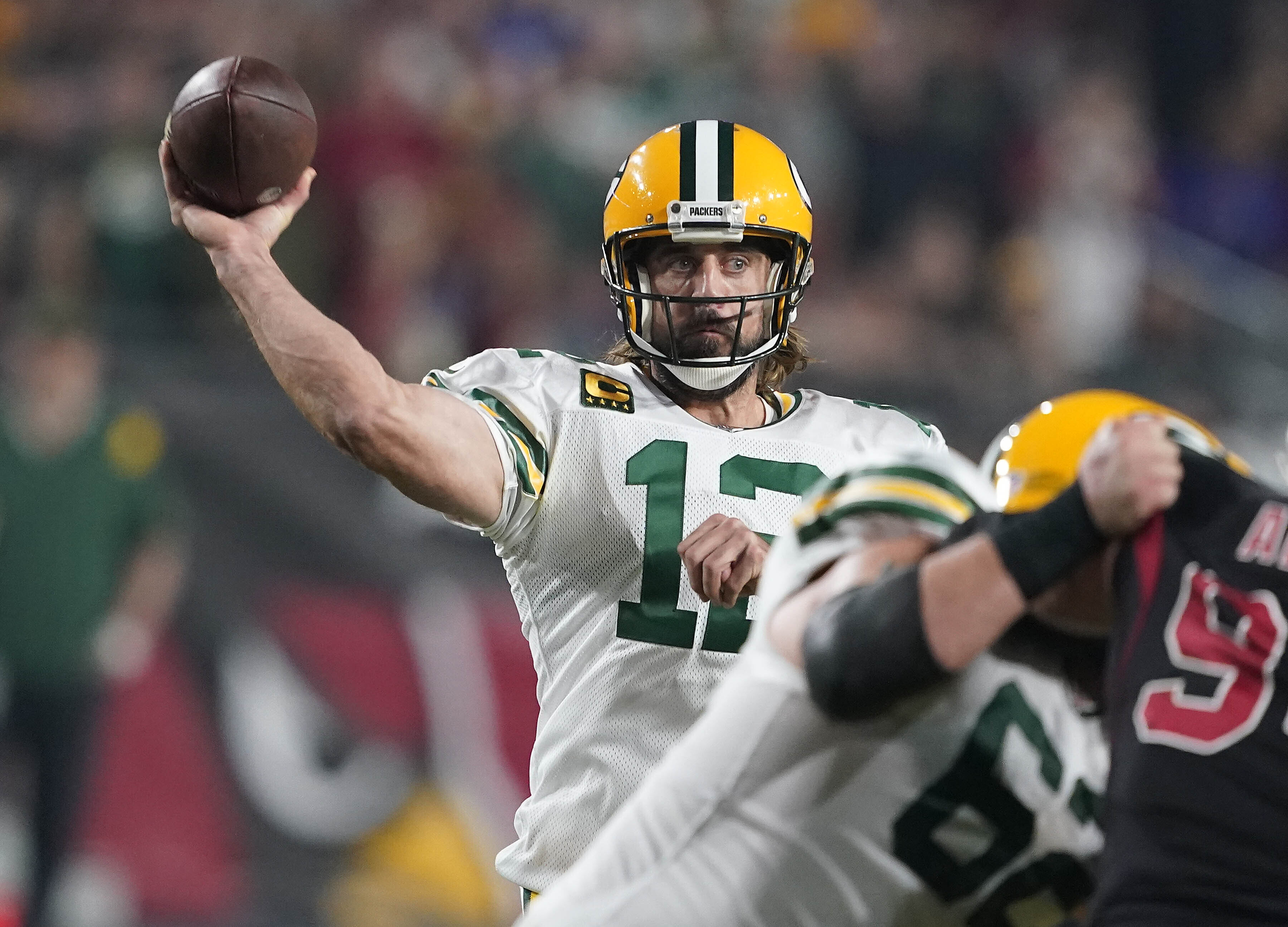 Green Bay Packers quarterback Aaron Rodgers (12) throws against the Arizona Cardinals in the first half of an NFL football game Thursday, Oct. 28, 2021, in Glendale, Ariz. (AP Photo/Darryl Webb)