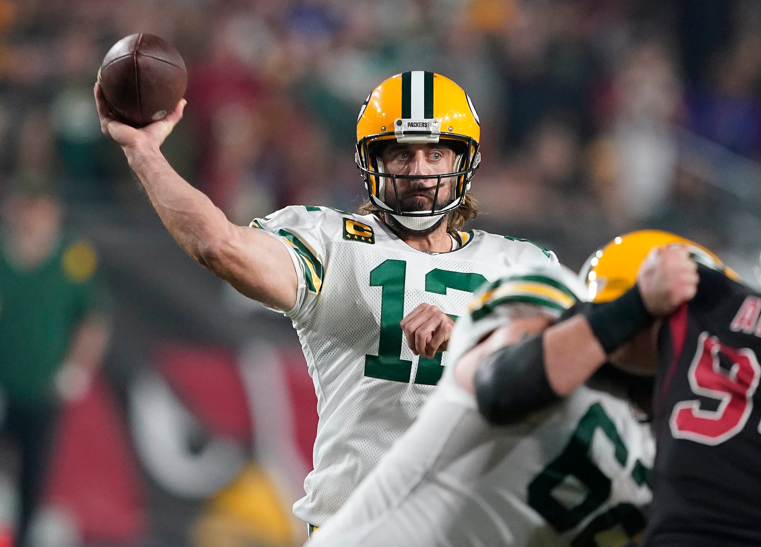 Green Bay Packers quarterback Aaron Rodgers (12) throws against the Arizona Cardinals in the first half of an NFL football game Thursday, Oct. 28, 2021, in Glendale, Ariz. (AP Photo/Darryl Webb)