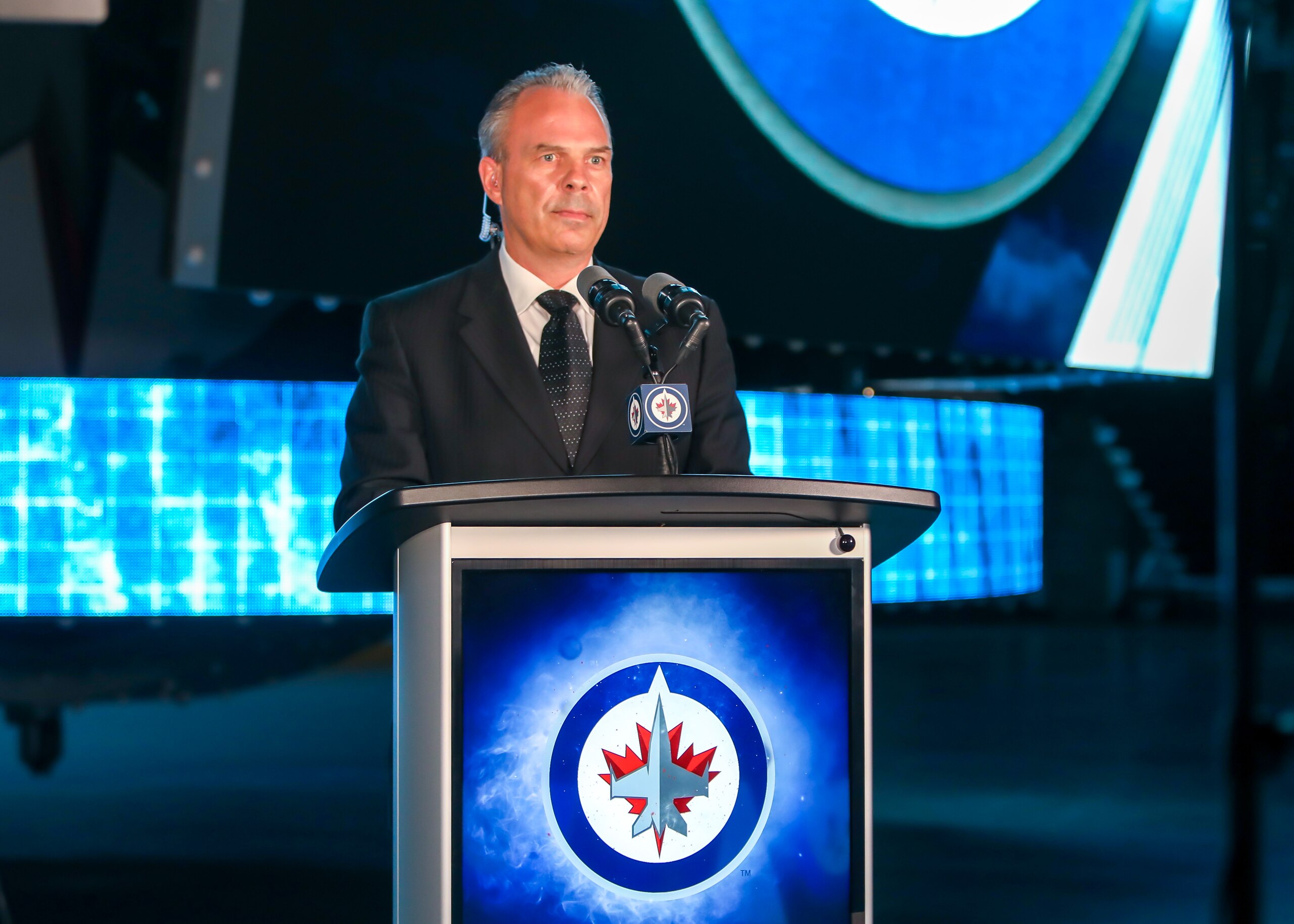 WINNIPEG, MANITOBA - JULY 23: Winnipeg Jets General Manager Kevin Cheveldayoff stands at the podium as the Jets prepare to select Chaz Lucius eighteenth overall in the first round of the 2021 NHL Draft at Canada Life Centre on July 23, 2021 in Winnipeg, Manitoba, Canada. The 2021 NHL Draft was held virtually due to the ongoing Coronavirus pandemic. (Photo by Jonathan Kozub/NHLI via Getty Images)