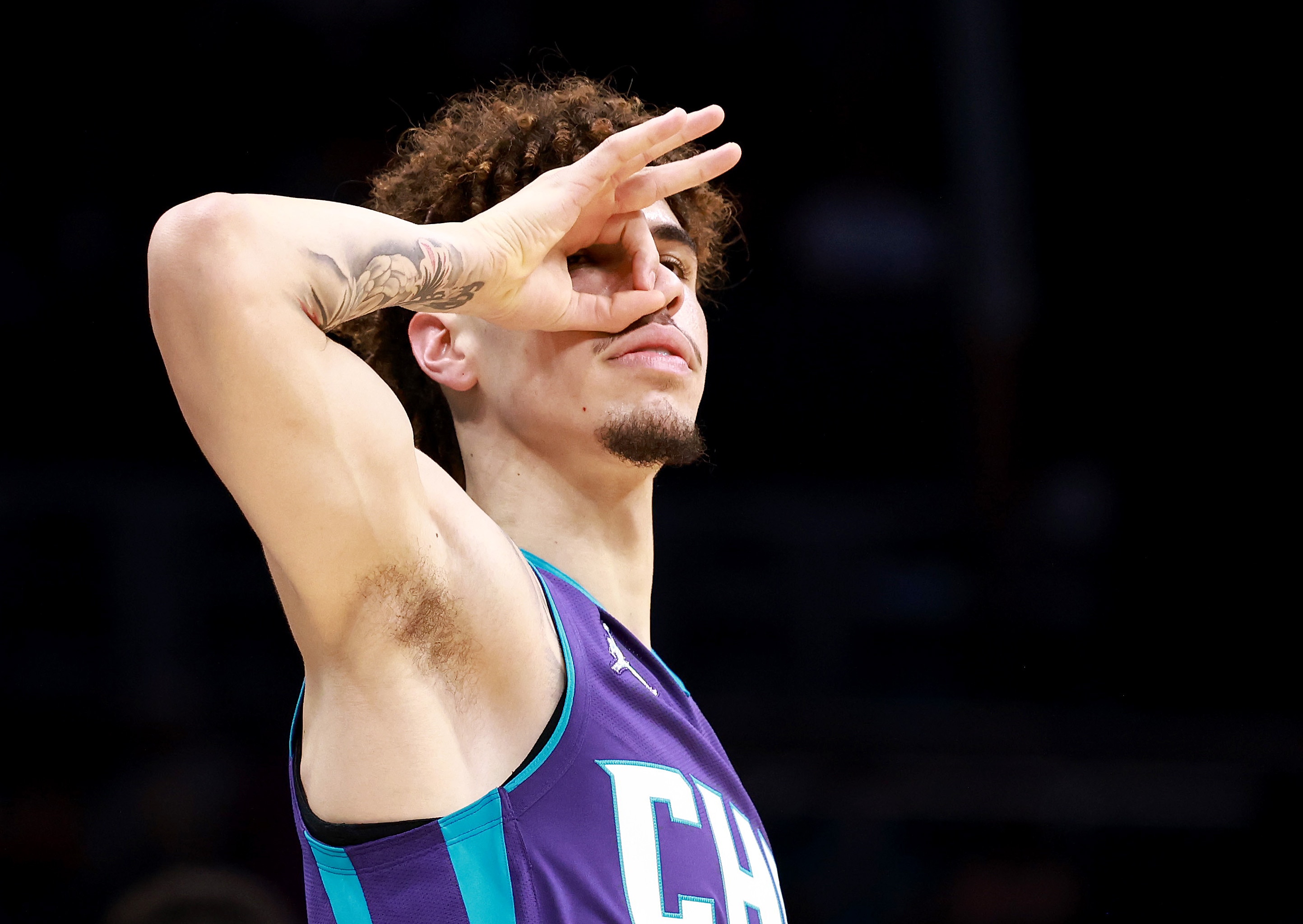 CHARLOTTE, NORTH CAROLINA - OCTOBER 25: LaMelo Ball #2 of the Charlotte Hornets reacts after making a three-point basket against the Boston Celtics during the first half of their game at Spectrum Center on October 25, 2021 in Charlotte, North Carolina. NOTE TO USER: User expressly acknowledges and agrees that, by downloading and/or using this Photograph, user is consenting to the terms and conditions of the Getty Images License Agreement.  (Photo by Grant Halverson/Getty Images)