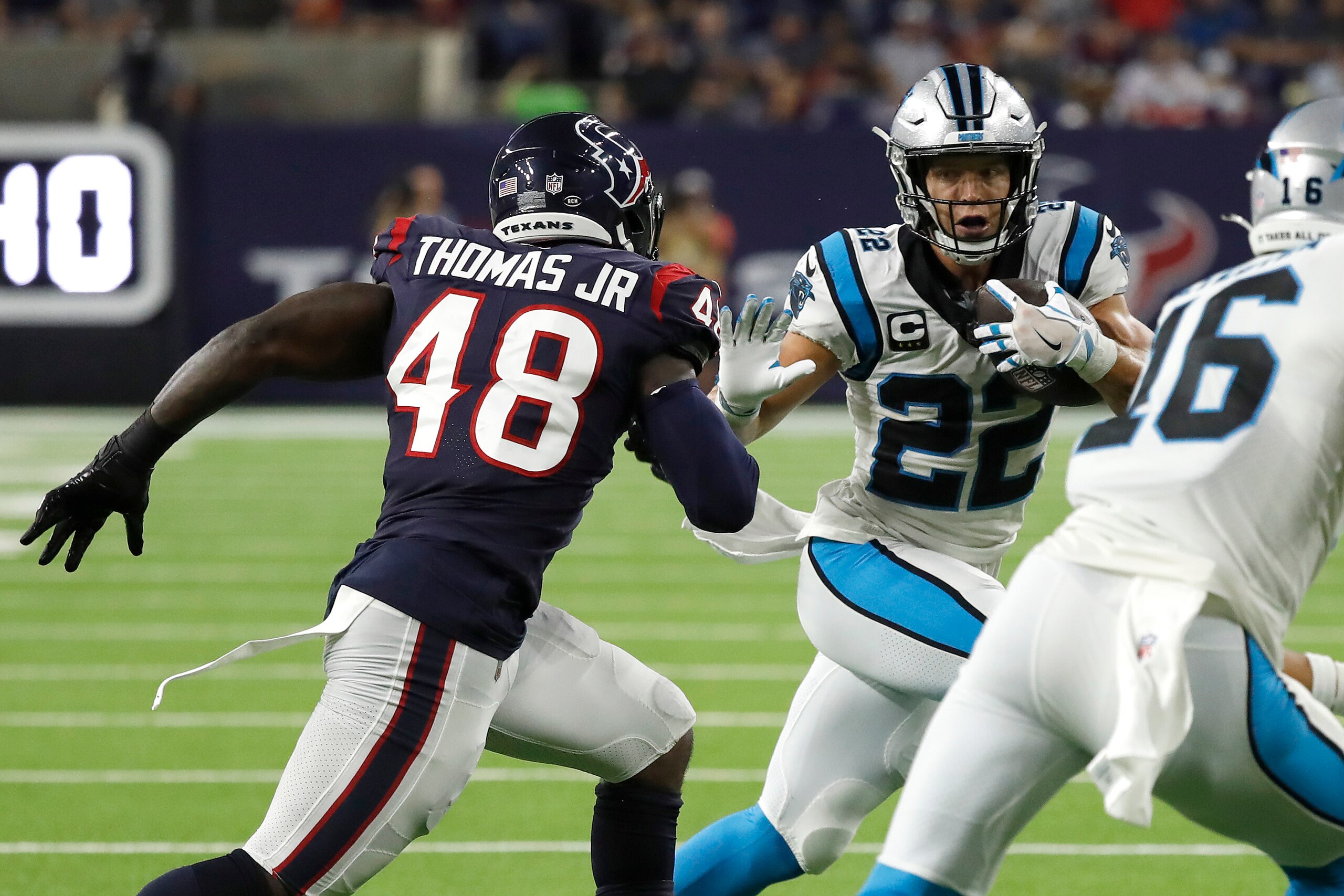 HOUSTON, TEXAS - SEPTEMBER 23: Christian McCaffrey #22 of the Carolina Panthers tries to get around the tackle of Joe Thomas #48 of the Houston Texans during a first half run at NRG Stadium on September 23, 2021 in Houston, Texas. (Photo by Bob Levey/Getty Images)