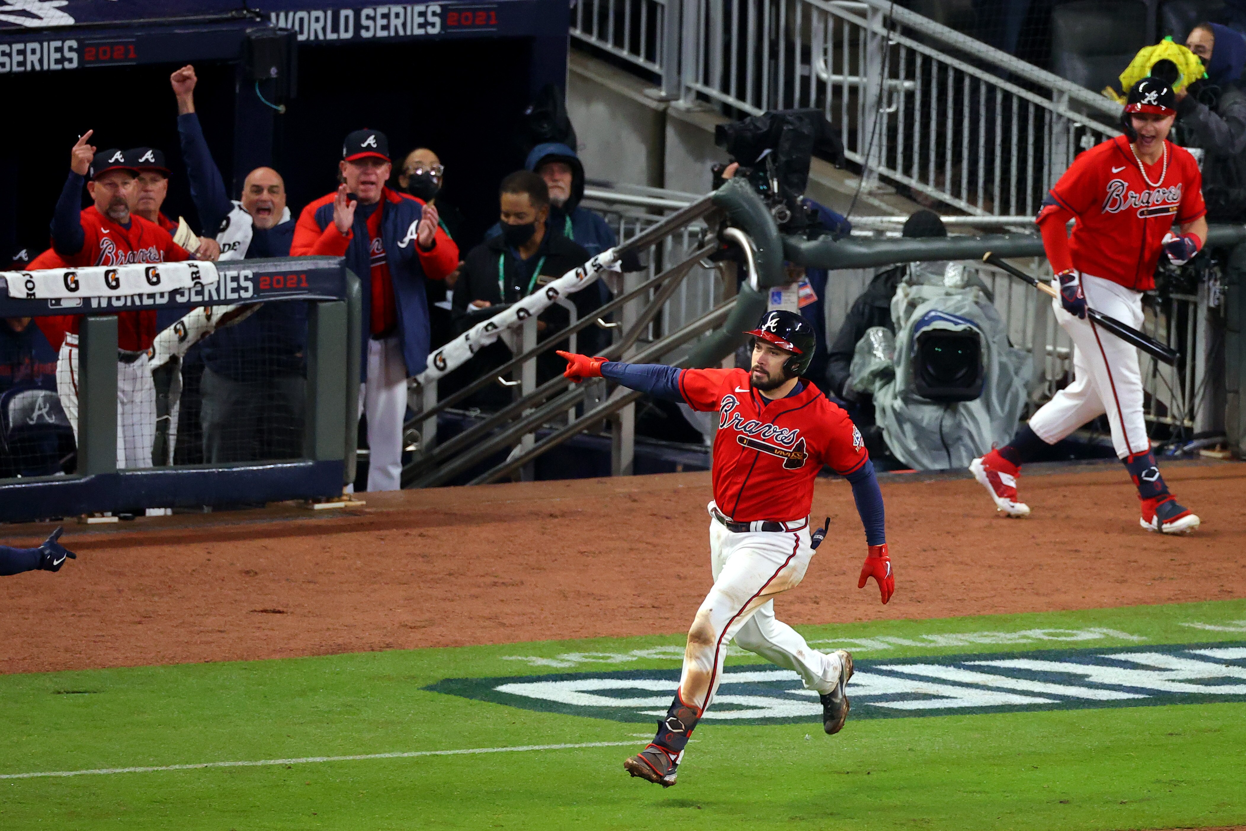 ATLANTA, GEORGIA - OCTOBER 29:  Travis d'Arnaud #16 of the Atlanta Braves celebrates after hitting a one run home run against the Houston Astros during the eighth inning in Game Three of the World Series at Truist Park on October 29, 2021 in Atlanta, Georgia. (Photo by Todd Kirkland/Getty Images)