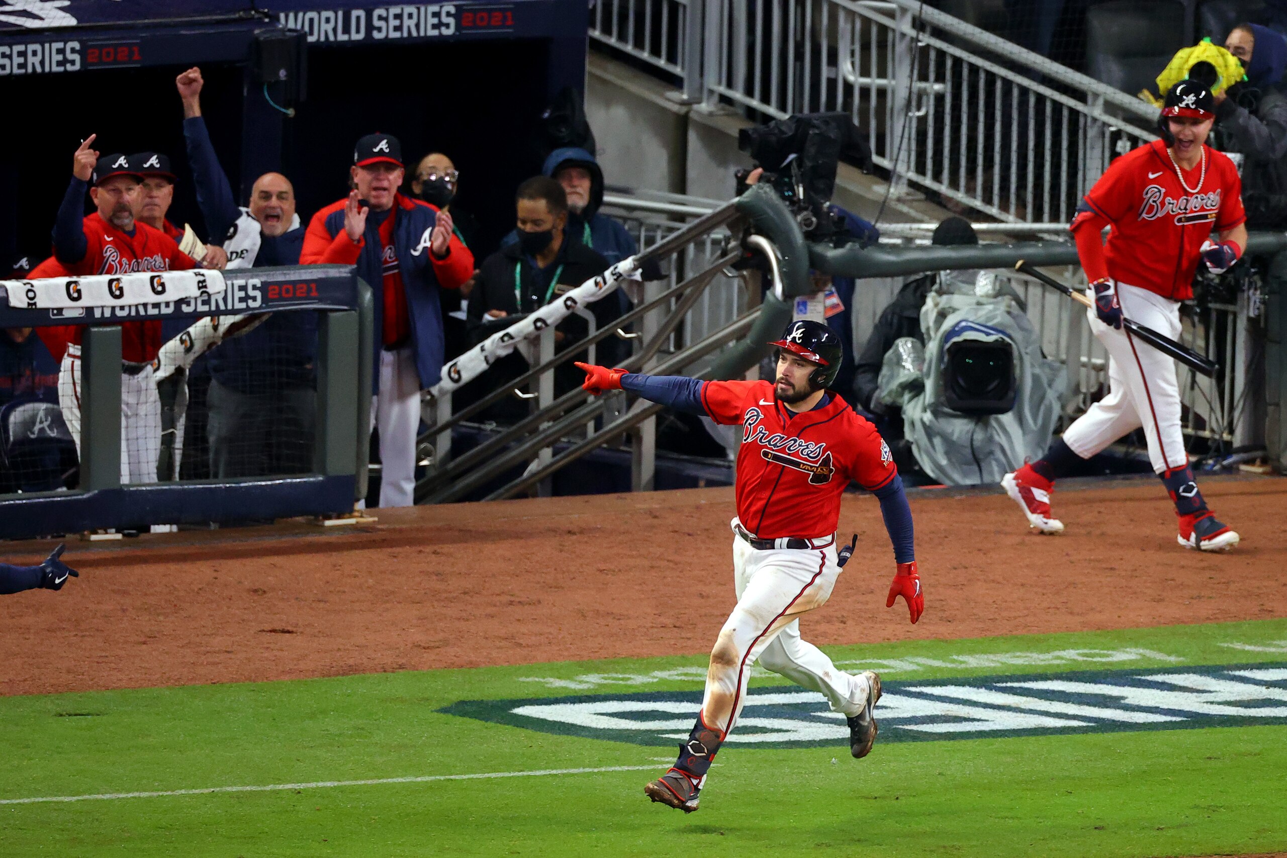 ATLANTA, GEORGIA - OCTOBER 29:  Travis d'Arnaud #16 of the Atlanta Braves celebrates after hitting a one run home run against the Houston Astros during the eighth inning in Game Three of the World Series at Truist Park on October 29, 2021 in Atlanta, Georgia. (Photo by Todd Kirkland/Getty Images)