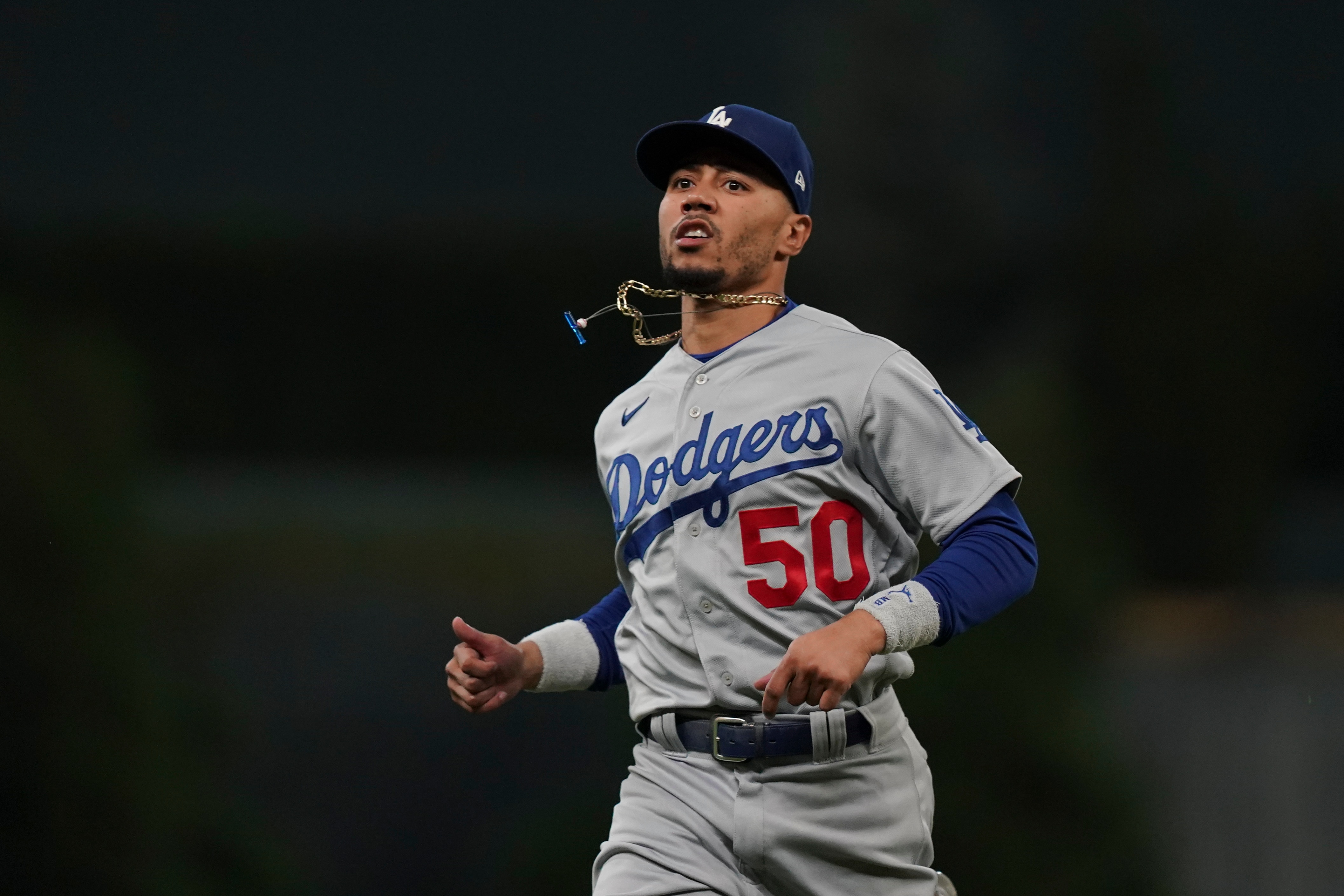 Los Angeles Dodgers right fielder Mookie Betts runs out of the dugout before Game 6 of baseball's National League Championship Series against the Atlanta Braves Saturday, Oct. 23, 2021, in Atlanta. (AP Photo/Brynn Anderson)