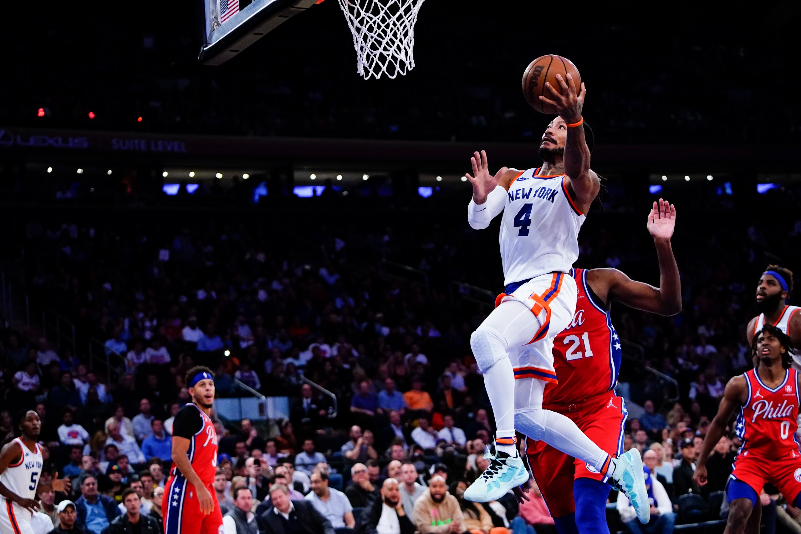 New York Knicks' Derrick Rose (4) drives past Philadelphia 76ers' Joel Embiid during the second half of an NBA basketball game Tuesday, Oct. 26, 2021, in New York. The Knicks won 112-99. (AP Photo/Frank Franklin II)