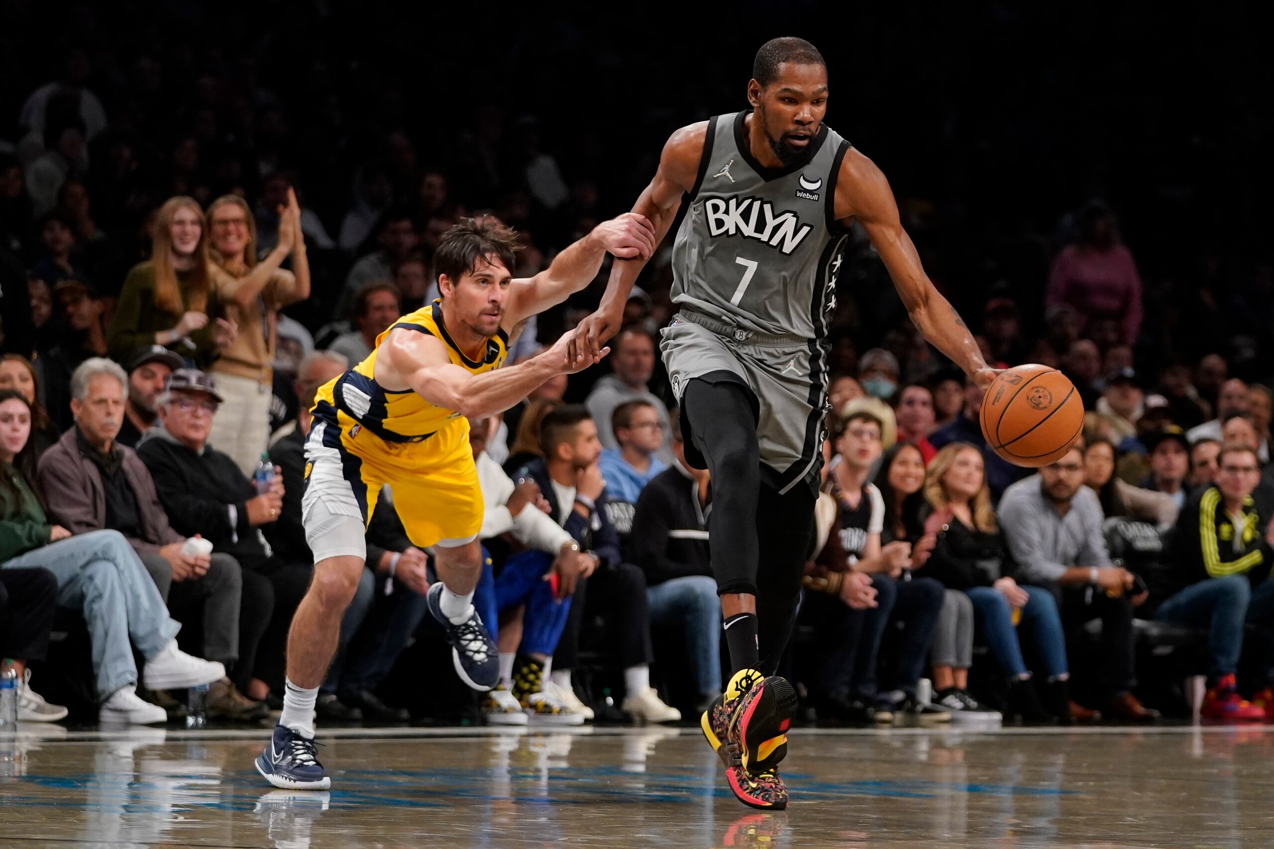 Brooklyn Nets forward Kevin Durant (7) drives against Indiana Pacers guard T.J. McConnell during the second half of an NBA basketball game, Friday, Oct. 29, 2021, in New York. The Nets won 105-98. (AP Photo/Mary Altaffer)