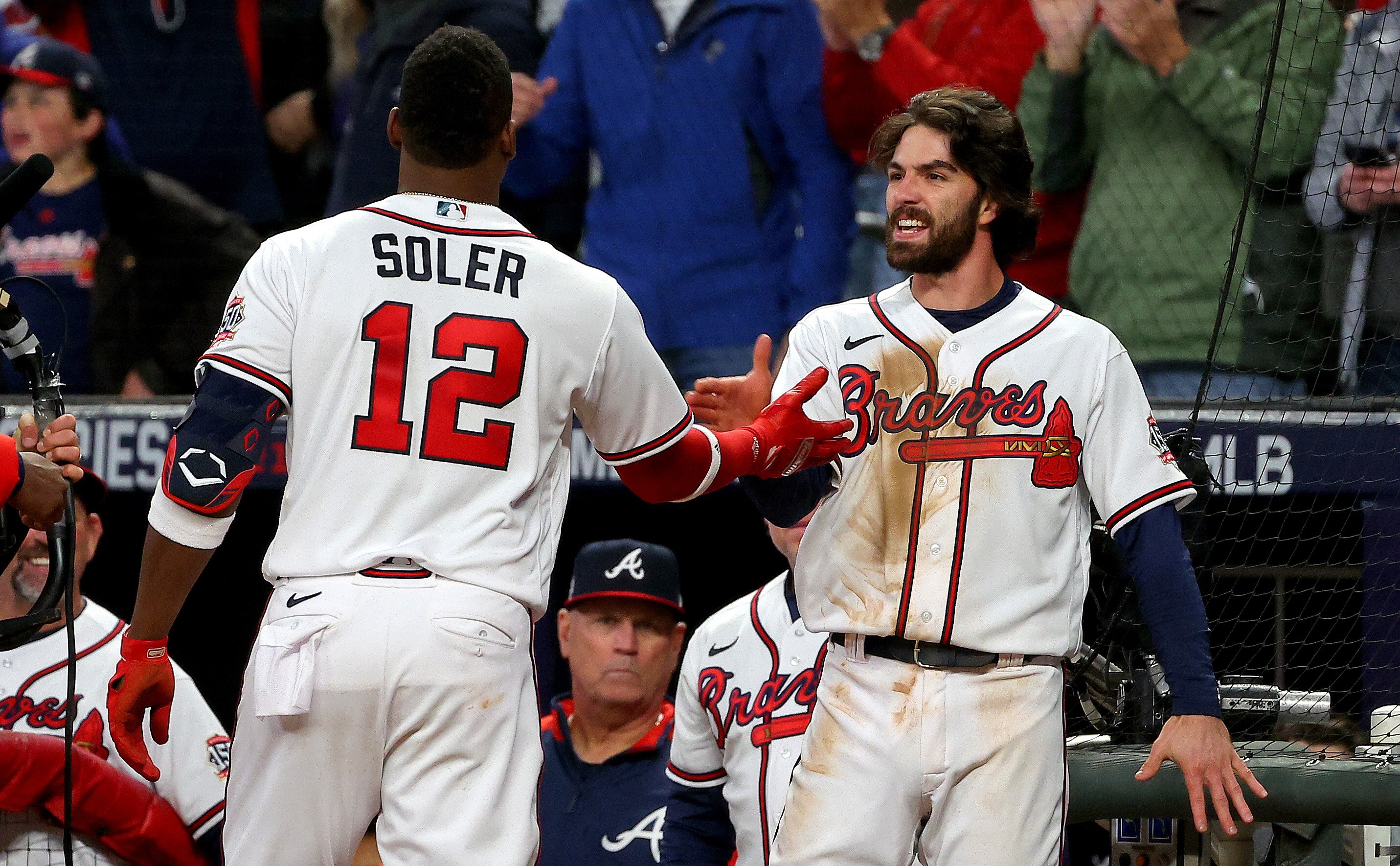 ATLANTA, GEORGIA - OCTOBER 30:  Jorge Soler #12 of the Atlanta Braves is congratulated by Dansby Swanson #7 after they hit back-to-back solo home runs against the Houston Astros during the seventh inning in Game Four of the World Series at Truist Park on October 30, 2021 in Atlanta, Georgia. (Photo by Kevin C. Cox/Getty Images)
