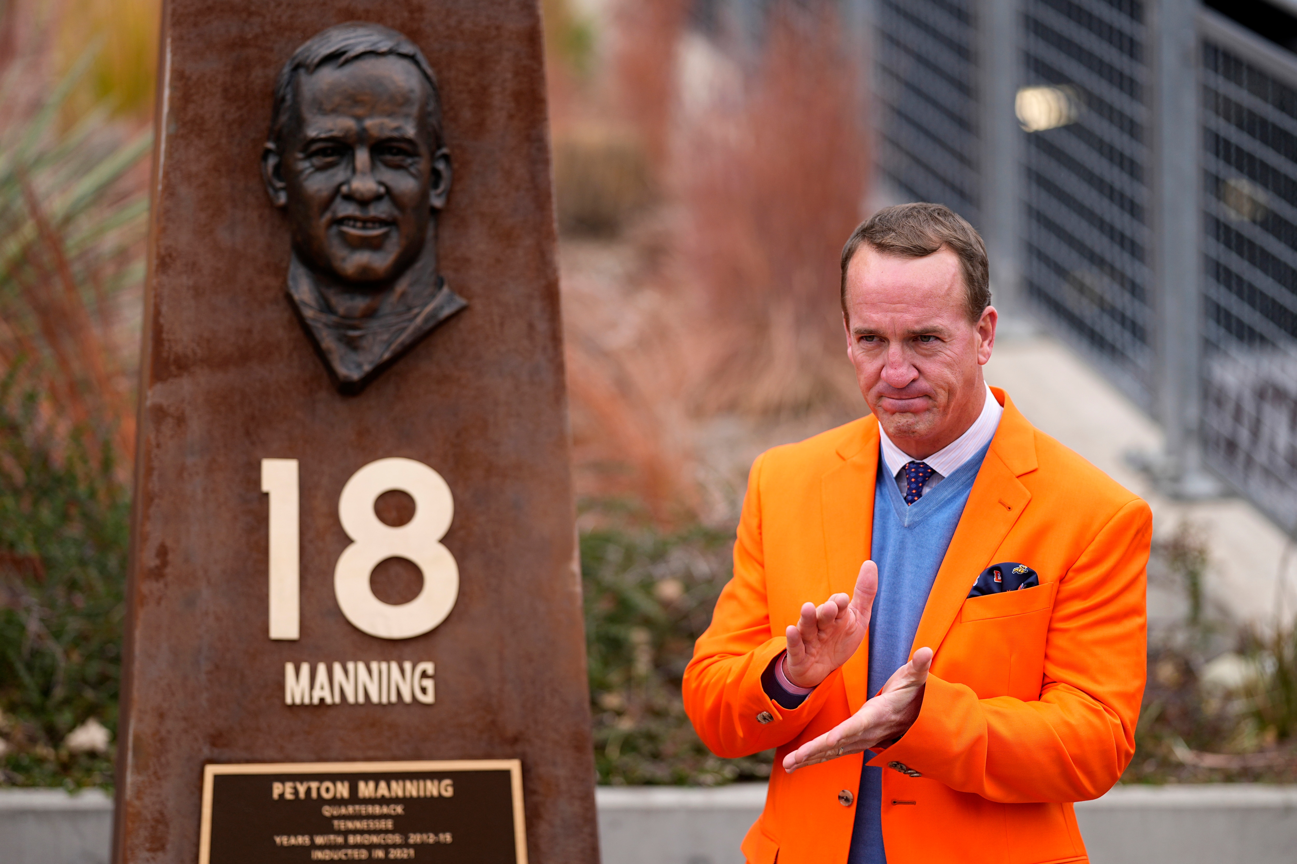 Peyton Manning stands next to his Denver Broncos Ring of Honor pillar after its unveiling prior to an NFL football game against the Washington Football Team, Sunday, Oct. 31, 2021, in Denver. (AP Photo/Jack Dempsey)