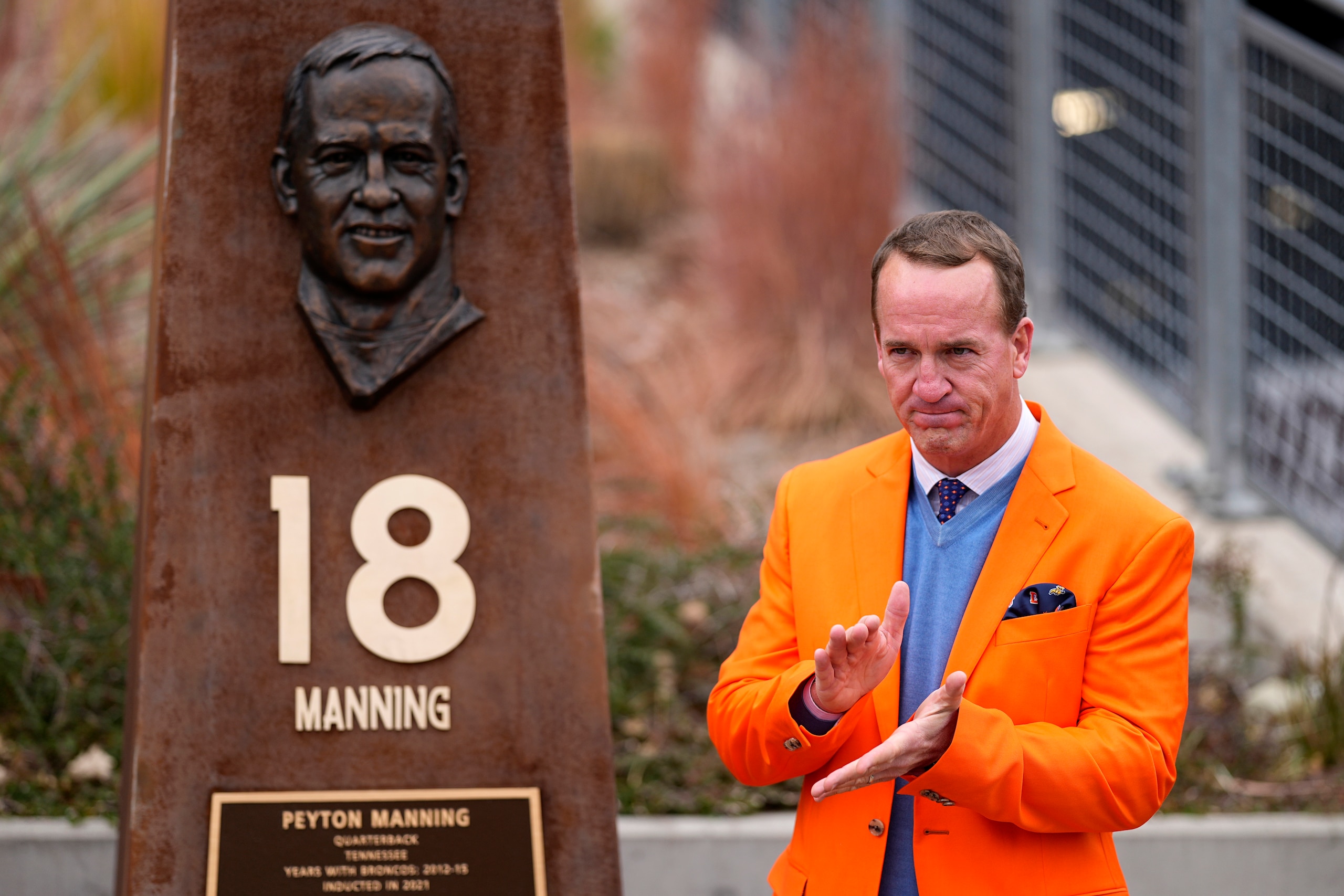 Peyton Manning stands next to his Denver Broncos Ring of Honor pillar after its unveiling prior to an NFL football game against the Washington Football Team, Sunday, Oct. 31, 2021, in Denver. (AP Photo/Jack Dempsey)