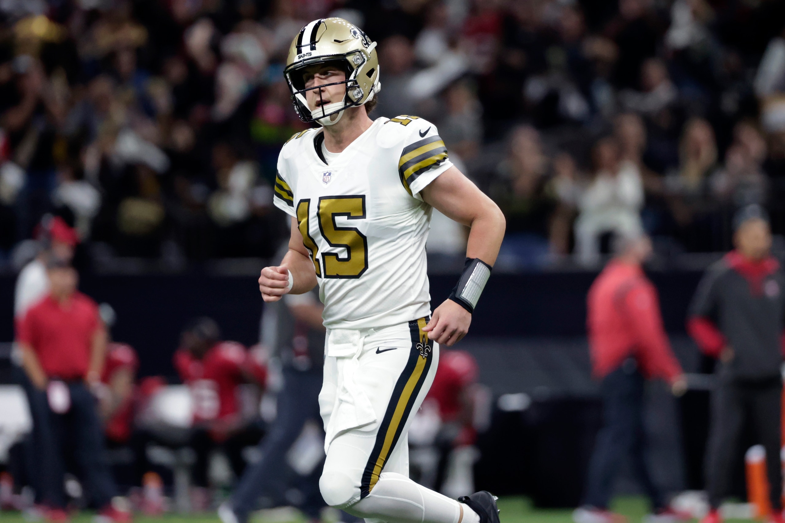 New Orleans Saints quarterback Trevor Siemian (15) runs off the field after throwing a touchdown reception in the first half of an NFL football game against the Tampa Bay Buccaneers in New Orleans, Sunday, Oct. 31, 2021. (AP Photo/Derick Hingle)