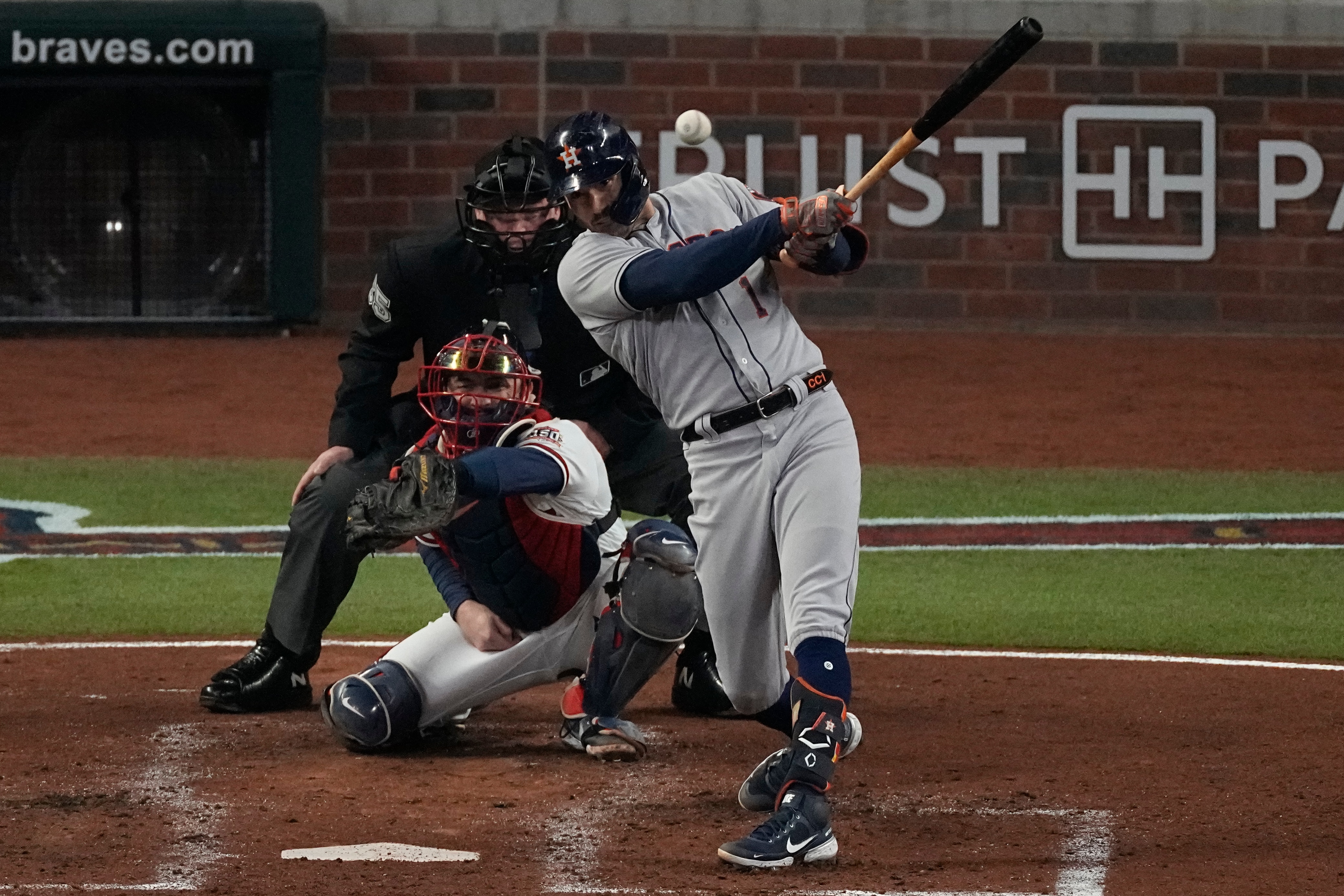 Houston Astros' Carlos Correa hits an RBI-double during the third inning in Game 5 of baseball's World Series between the Houston Astros and the Atlanta Braves Sunday, Oct. 31, 2021, in Atlanta. (AP Photo/John Bazemore)